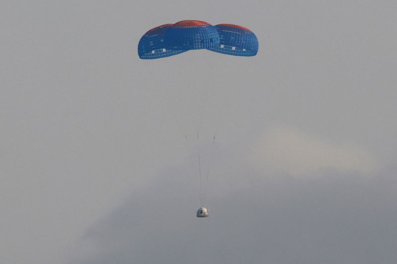 The capsule carrying billionaire businessman Jeff Bezos and three crew members returns by parachute after their flight aboard Blue Origin's New Shepard rocket near Van Horn, Texas , U.S., July 20, 2021.