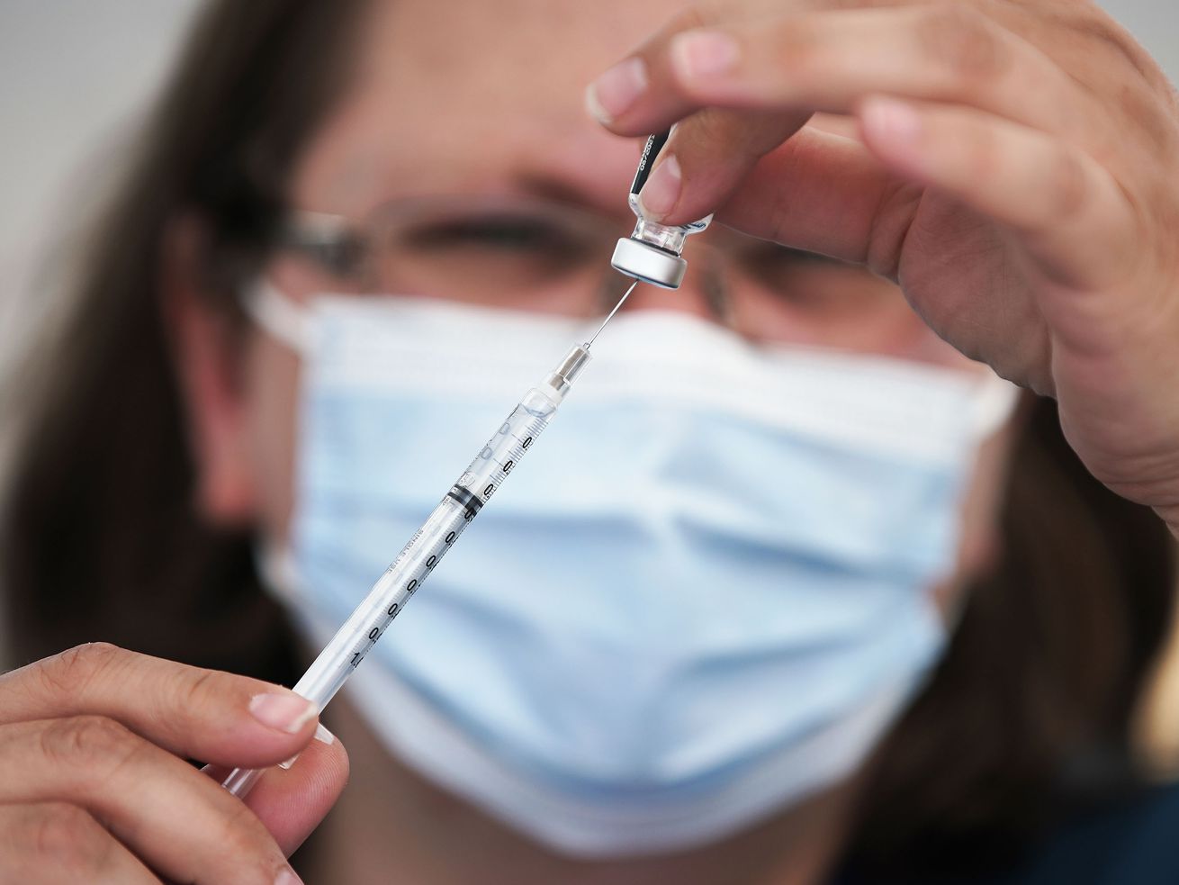 Clarece Glanville prepares a COVID-19 vaccination at pop-up clinic sponsored by the Davis County Health Department in the parking lot of Kent’s Market in Clearfield on Wednesday, June 23, 2021. Sen. Mitt Romney, R-Utah, said Tuesday he and others are
ready for a COVID-19 booster shot and expressed frustration during a Senate hearing that a third vaccination against the deadly virus is already available in some countries including Israel but not the United States.
