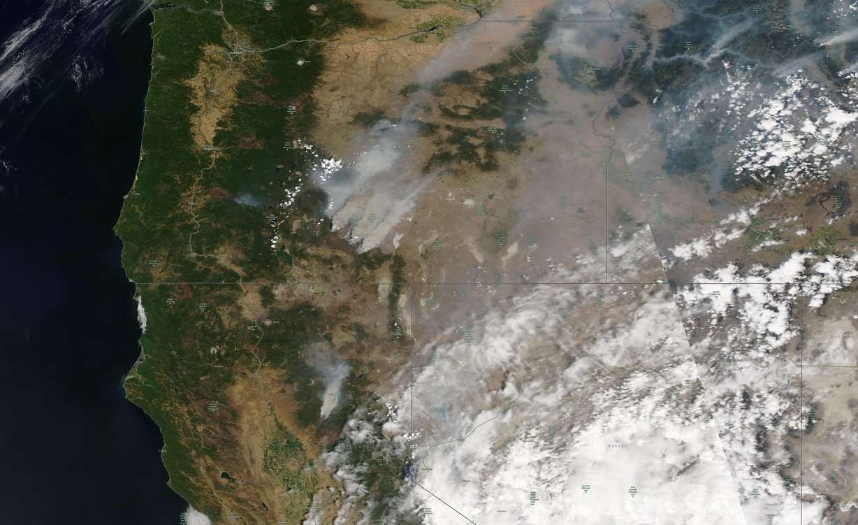 This satellite image shows overview of wildfires from Oregon, Idaho, and Northern California on Sunday, July 18, 2021. Extremely dry conditions and heat waves tied to climate change have made wildfires harder to fight.