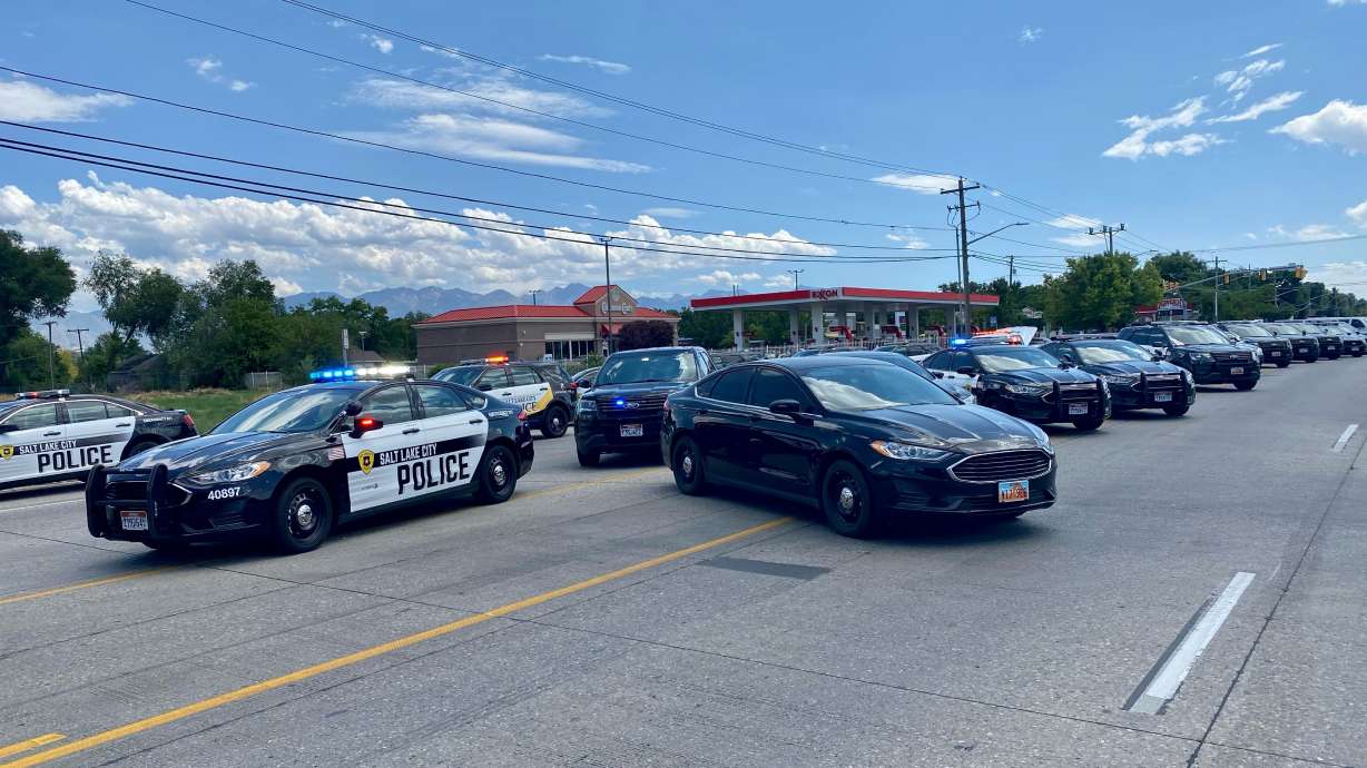Police vehicles fill a closed section of Redwood Road near 800 North and Redwood Road in Salt Lake City on Tuesday, July 20, 2021. Police say a man barricaded himself in a home and exchanged gunfire with officers. The identity the man, who was later found dead, was released Wednesday.