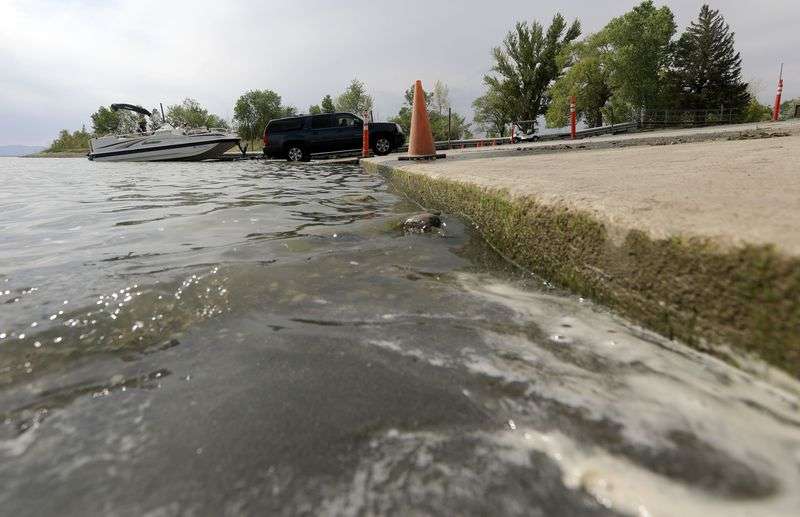 A boat is pulled from the water next to a boat ramp
that is closed and has an abrupt drop-off due to low water at the
Willard Bay North Marina in Willard, Box Elder County, on Monday,
July 19, 2021.
