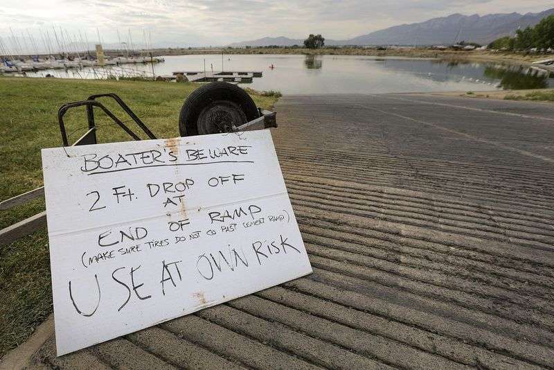 A sign warns boaters of low water and a boat ramp that
has a steep drop-off at Lindon Marina in Vineyard on Monday, July
19, 2021.