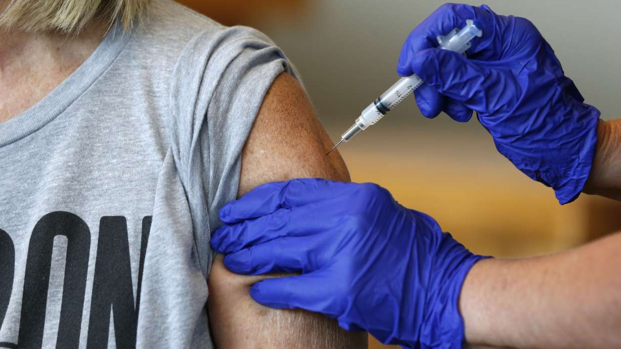 Karen Martin receives a COVID-19 vaccine in Springfield, Mo., on July 12, 2021. The five states with the biggest two-week jump in coronavirus cases per capita all had lower rates: Missouri, 45.9%; Arkansas, 43%, Nevada, 50.9%, Louisiana, 39.2% and Utah, 49.5%.