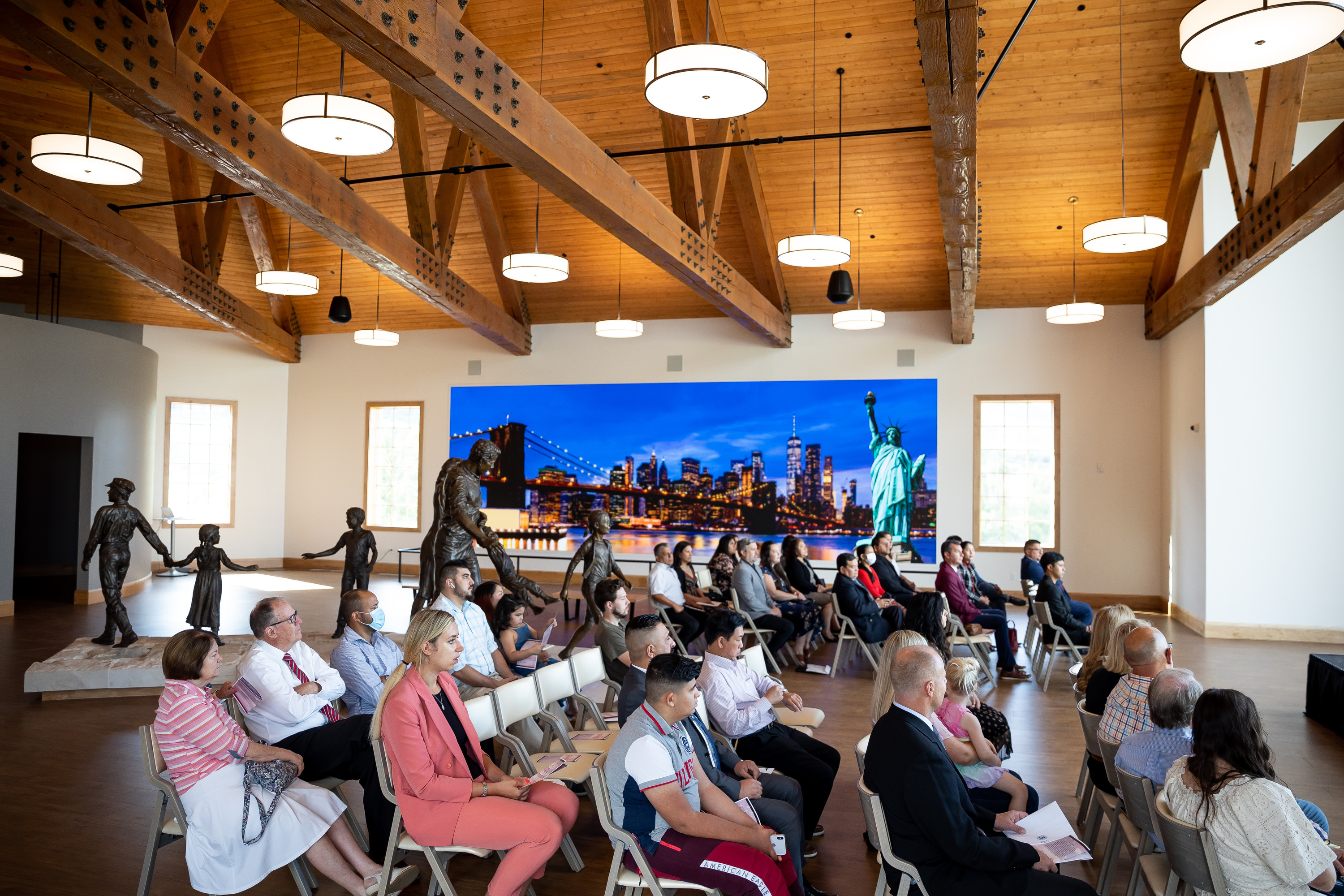 Soon-to-be U.S. citizens sit together during a naturalization ceremony at This is the Place Heritage Park in Salt Lake City on Wednesday, July 21, 2021.
