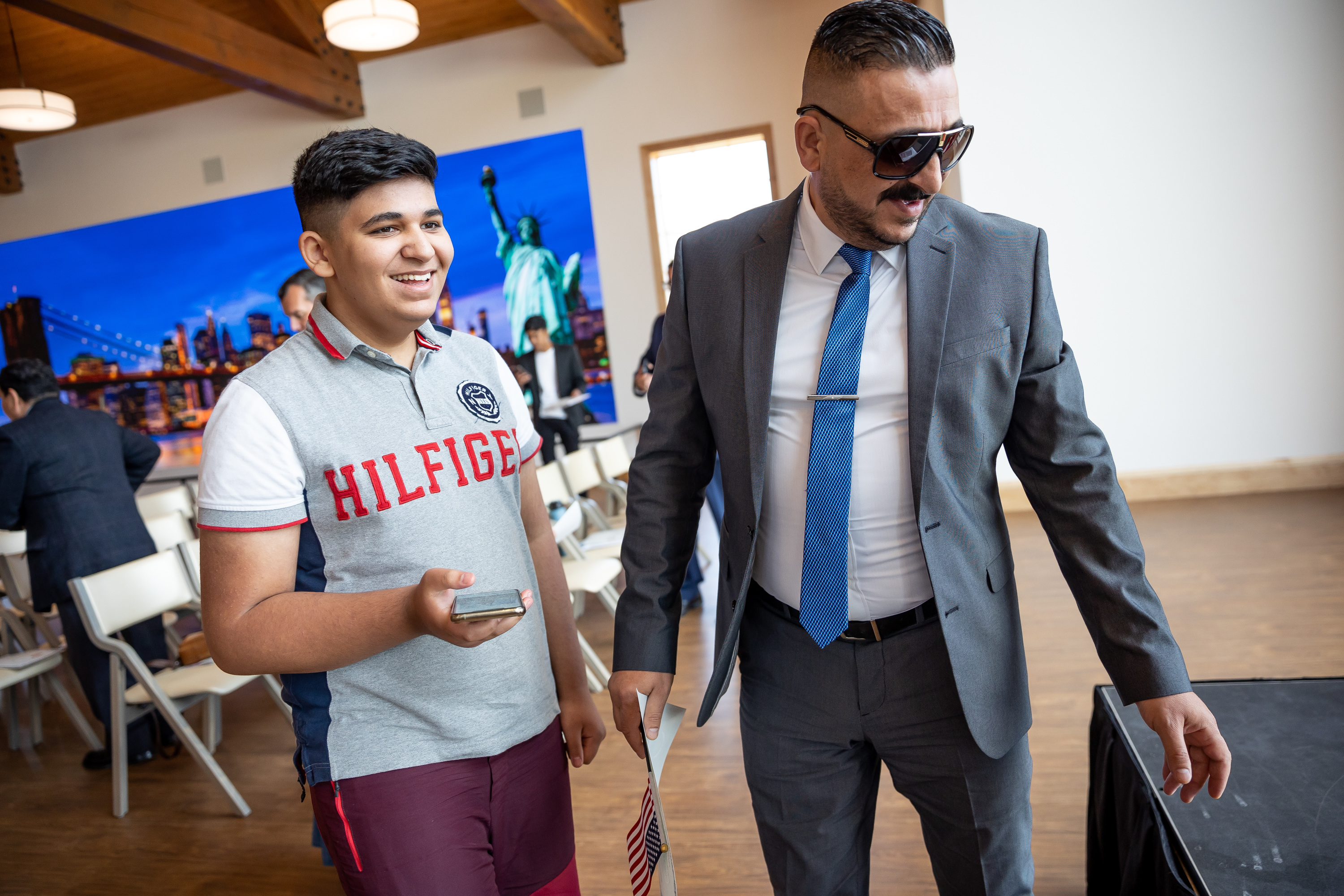 Radhwan Fadhil, right, and his son, Mohaimen Fadhil, celebrate after the elder Fadhil became a U.S. citizen at a naturalization ceremony at This is the Place Heritage Park in Salt Lake City on Wednesday, July 21, 2021. Radhwan Fadhil, formerly an Iraqi citizen, worked for the U.S. Army from 2004-2013 during the war, sustaining injuries including a gunshot wound, before leaving the country to come to the U.S.
