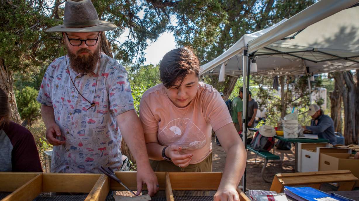 Weber State University students Alex Willie, left, and Abigail Cohen sort pottery shards and artifacts found at an ancestral Puebloan homestead site during Archeological Field School in southeastern Utah Thursday.