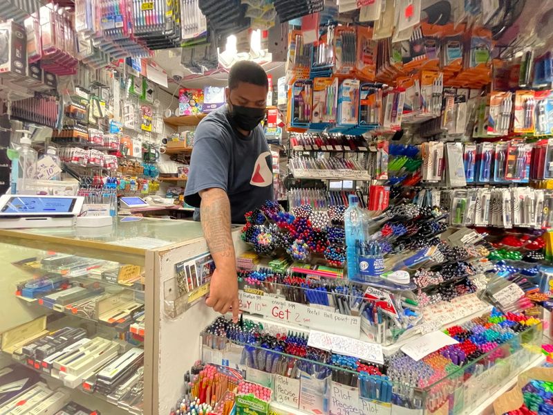 A staff member points to supplies on display at Stationery and Toy World in New York City, ahead of back-to-school season, July 21, 2021.