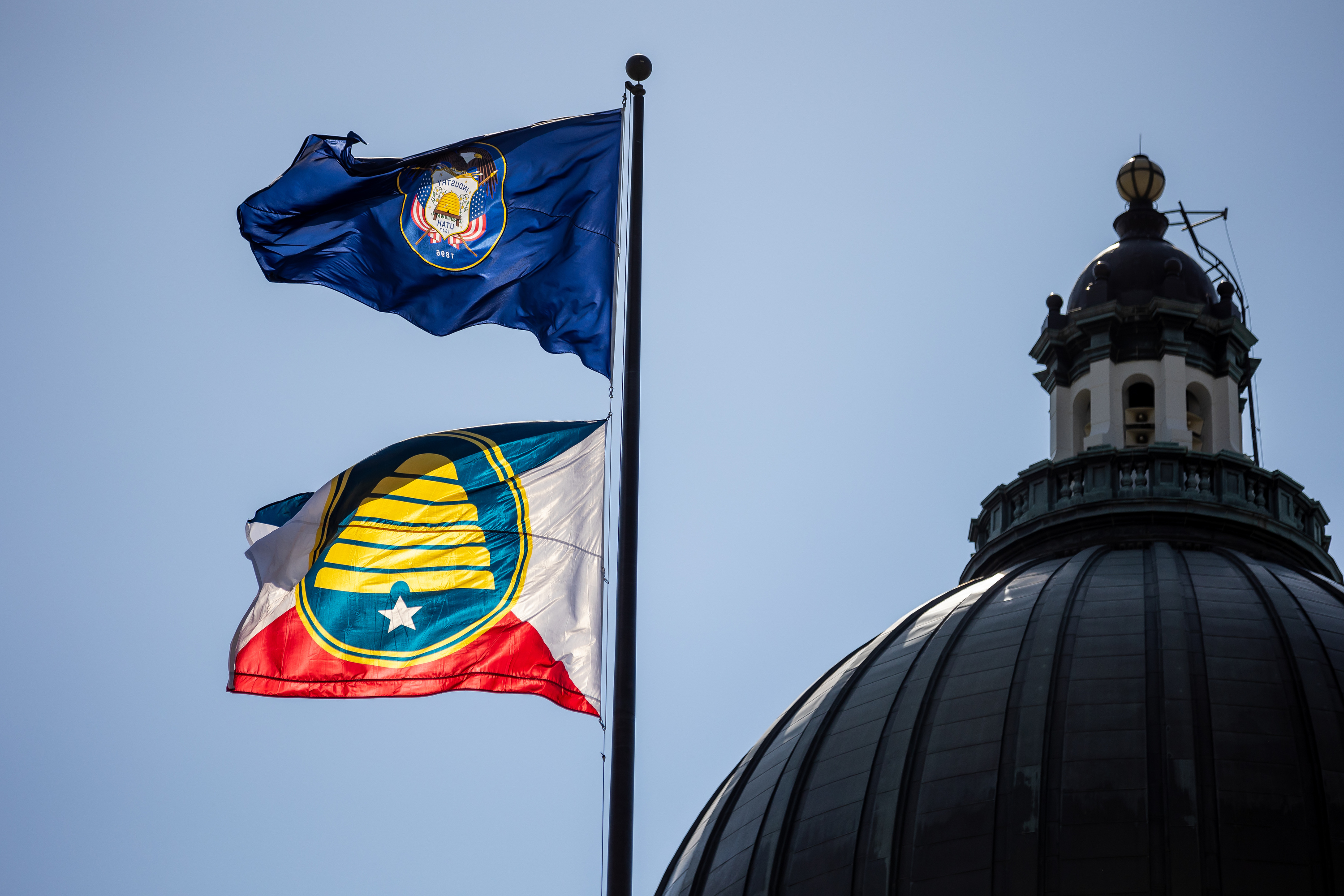 The Utah state flag, top, and a commemorative state flag, below, fly atop the Capitol in Salt Lake City on Tuesday, July 13, 2021. As Pioneer Day nears, the Utah League of Cities and Towns released a new lighthearted campaign Thursday aimed at getting national outlets to call people from Utah "Utahns."