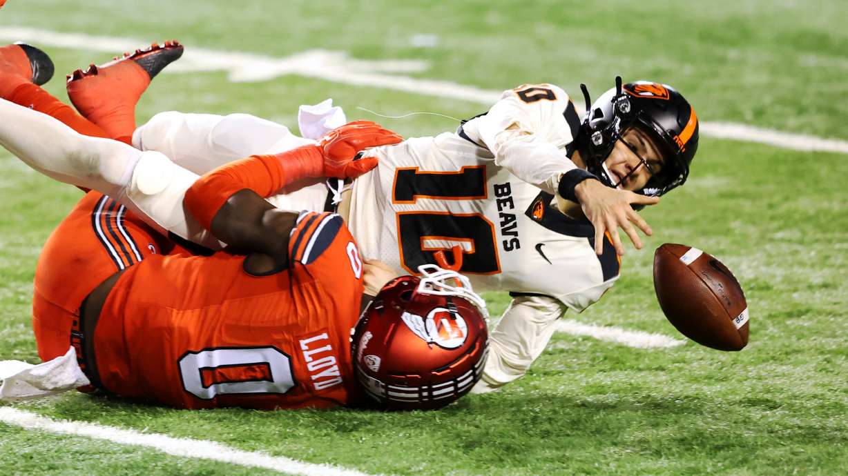 Oregon State Beavers quarterback Chance Nolan (10) reaches for the ball as he is sacked by Utah Utes linebacker Devin Lloyd (0) as Utah and Oregon State play a college football game at Rice-Eccles Stadium in Salt Lake City on Sunday, Dec. 6, 2020. Utah won 30-24.