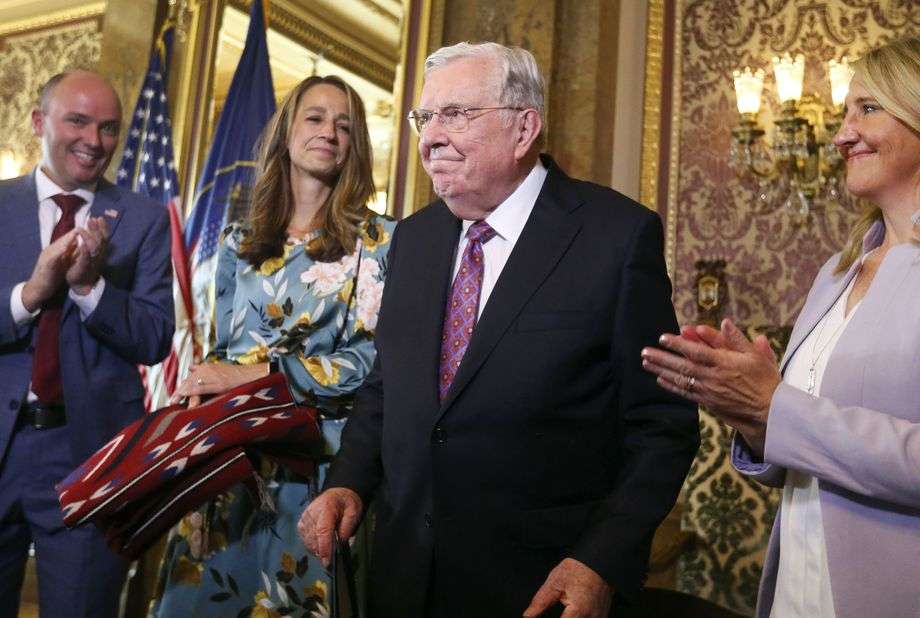 Gov. Spencer Cox, left, first lady Abby Cox, second from left, and state Rep. Melissa Garff Ballard, R-North Salt Lake, right, applaud as President M. Russell Ballard, acting president of the Quorum of the Twelve Apostles of The Church of Jesus Christ of Latter-day Saints, is recognized during a ceremony at the Capitol in Salt Lake City on Thursday, July 22, 2021.The governor declared Friday, July 23, 2021, as President M. Russell Ballard Day.