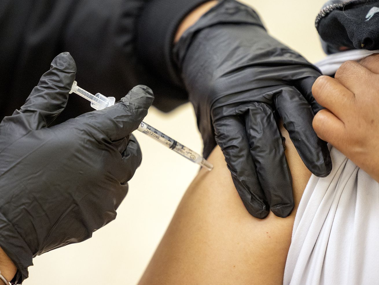 Patricia Lovos gives a COVID-19 vaccination to a woman at the Second Baptist Church in Ogden on May 8, 2021. For the first time during the pandemic, Utah's daily count of new COVID-19 cases surpassed 10,000 on Wednesday.