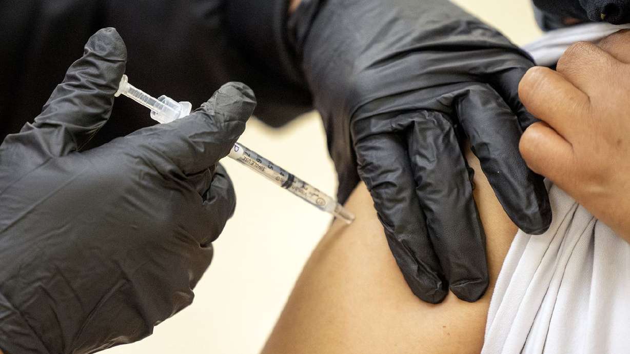 Patricia Lovos gives a COVID-19 vaccination to a woman at the Second Baptist Church in Ogden on May 8, 2021. For the first time during the pandemic, Utah's daily count of new COVID-19 cases surpassed 10,000 on Wednesday.