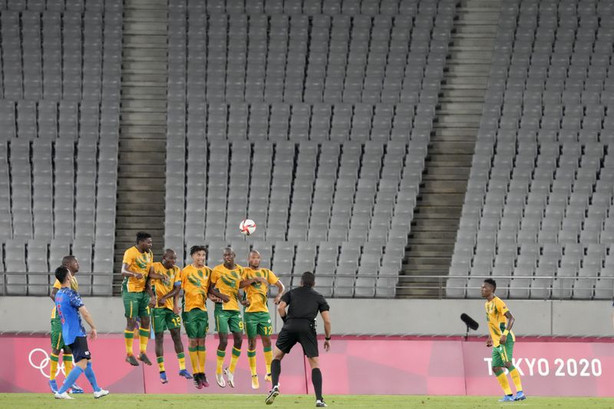 Japan’s Maya Yoshida, left, takes a penalty kick
against South Africa as the stands sit empty during a men’s soccer
match at the 2020 Summer Olympics on Thursday, July 22, 2021, in
Tokyo.