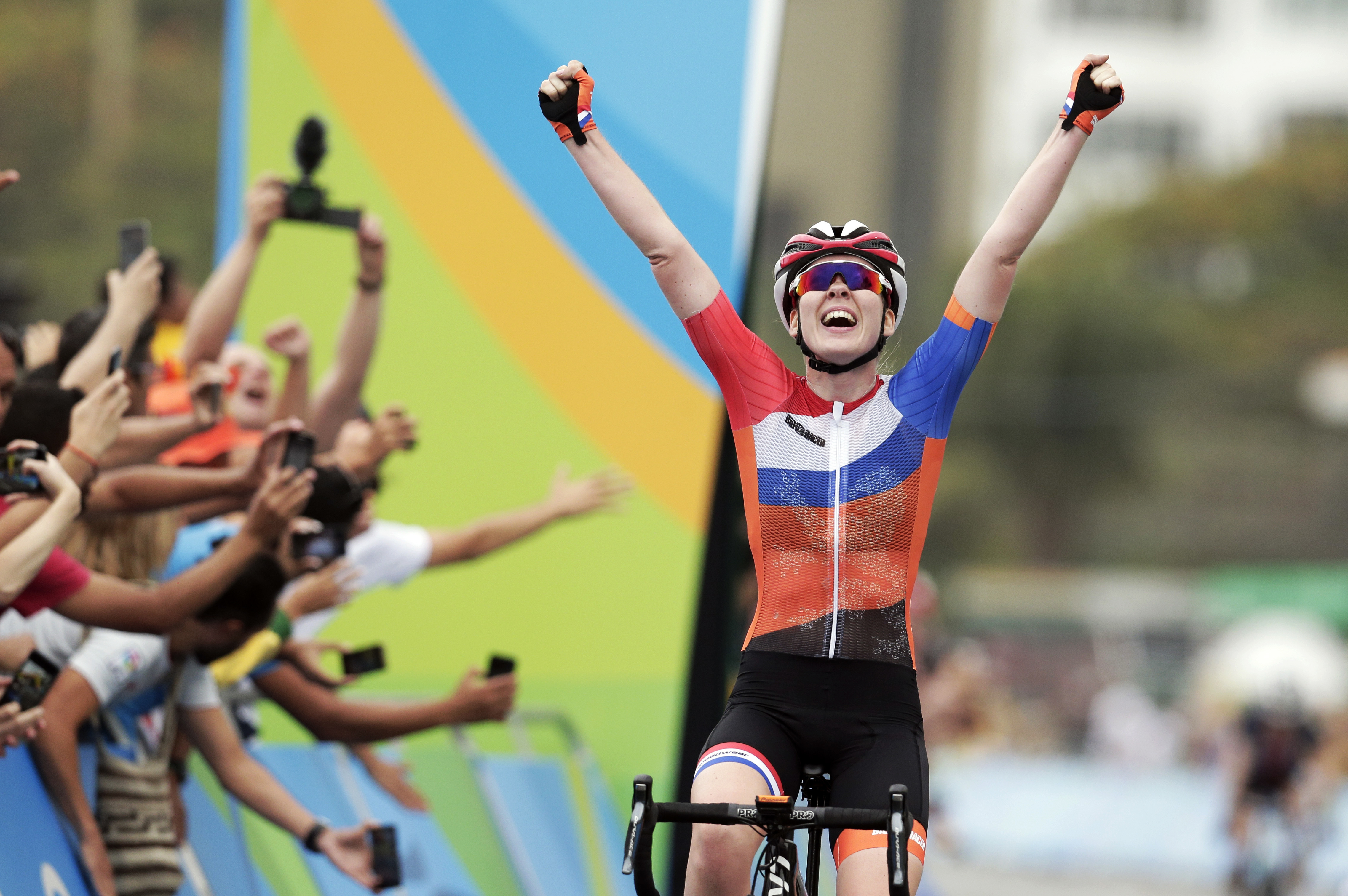 FILE - Anna Van Der Breggen, of the Netherlands, celebrates after crossing the finishing line to win the women's cycling road race final at the 2016 Summer Olympics in Rio de Janeiro, Brazil, in this Sunday, Aug. 7, 2016, file photo. The men's and women's road races kick off the cycling program at every Summer Olympics. “Everybody in the world is trying to figure out how to beat the Dutch girls,” said Jim Miller, the high performance director for USA Cycling.