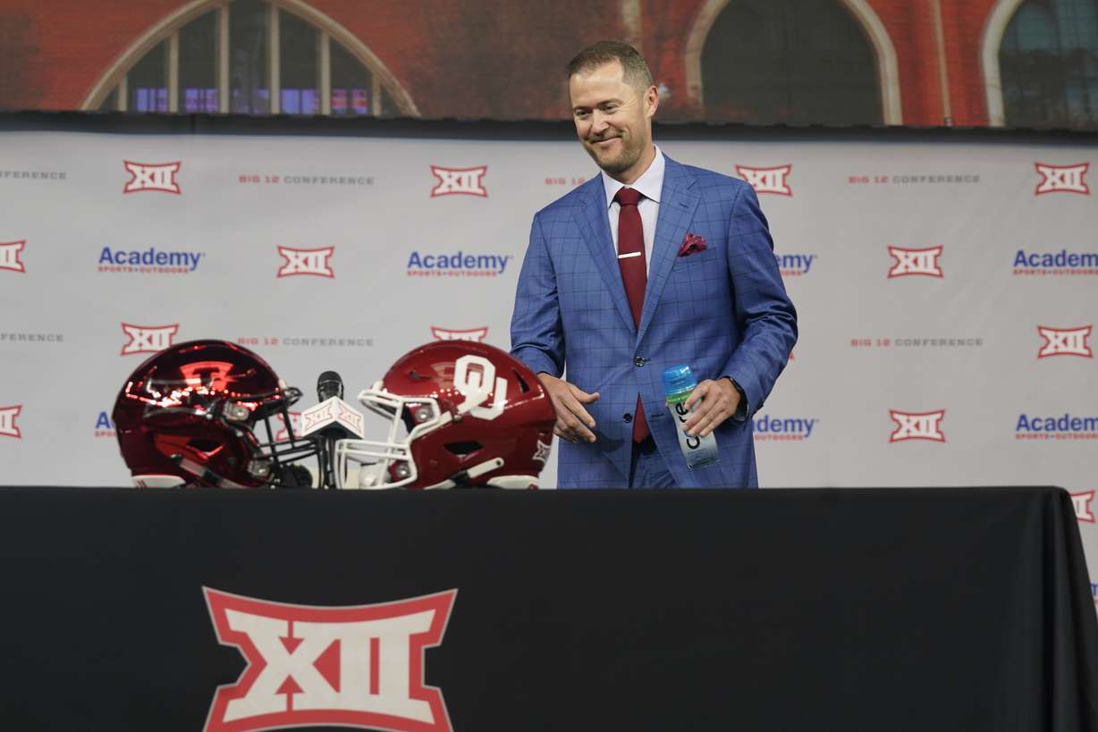 Oklahoma head football coach Lincoln Riley smiles as he heads to sit during NCAA college football Big 12 media days Wednesday, July 14, 2021, in Arlington, Texas.