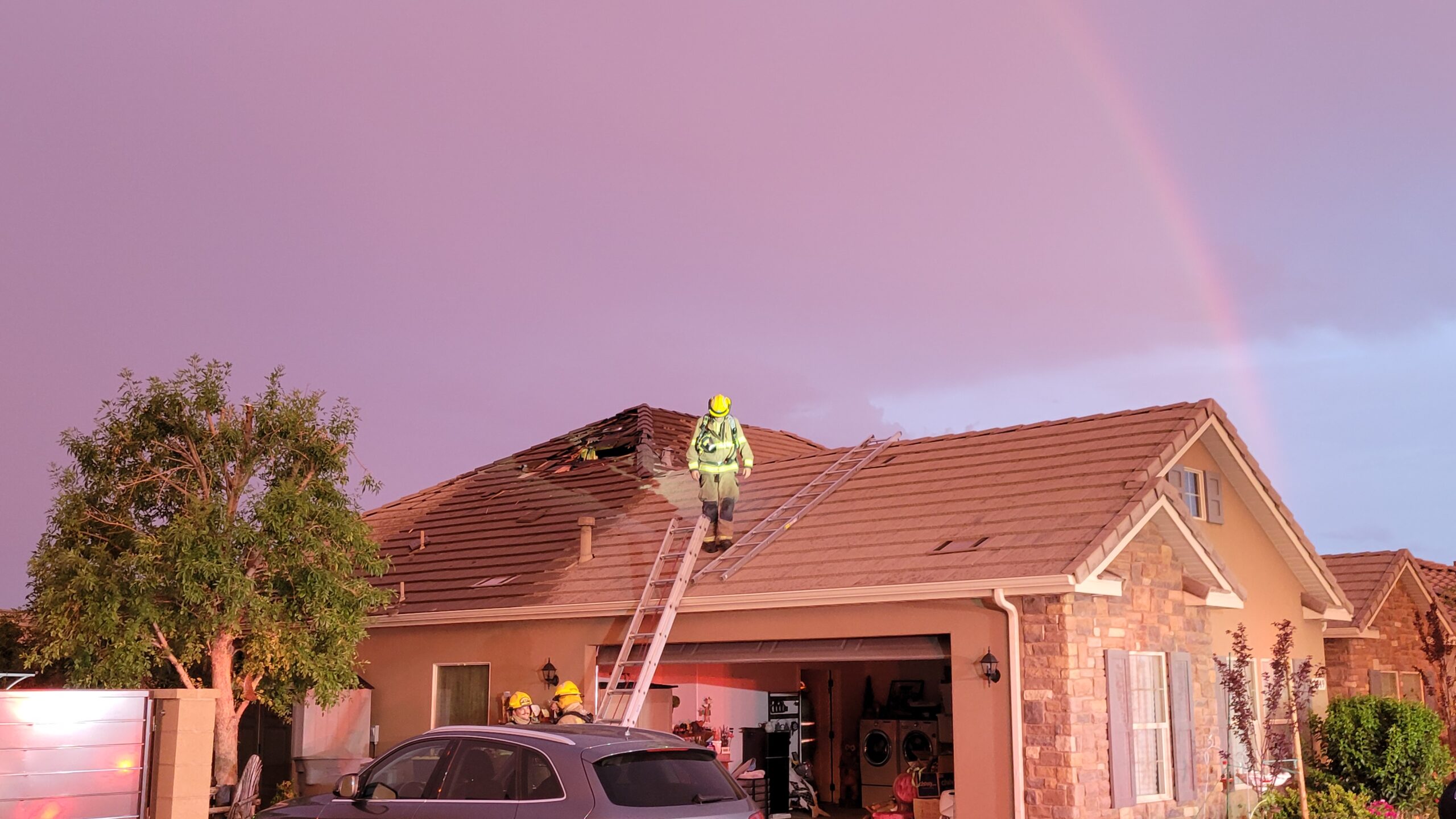 A rainbow appears above a home where a hole had been punched into the roof by a lightning bolt in St. George on July 22, 2021.