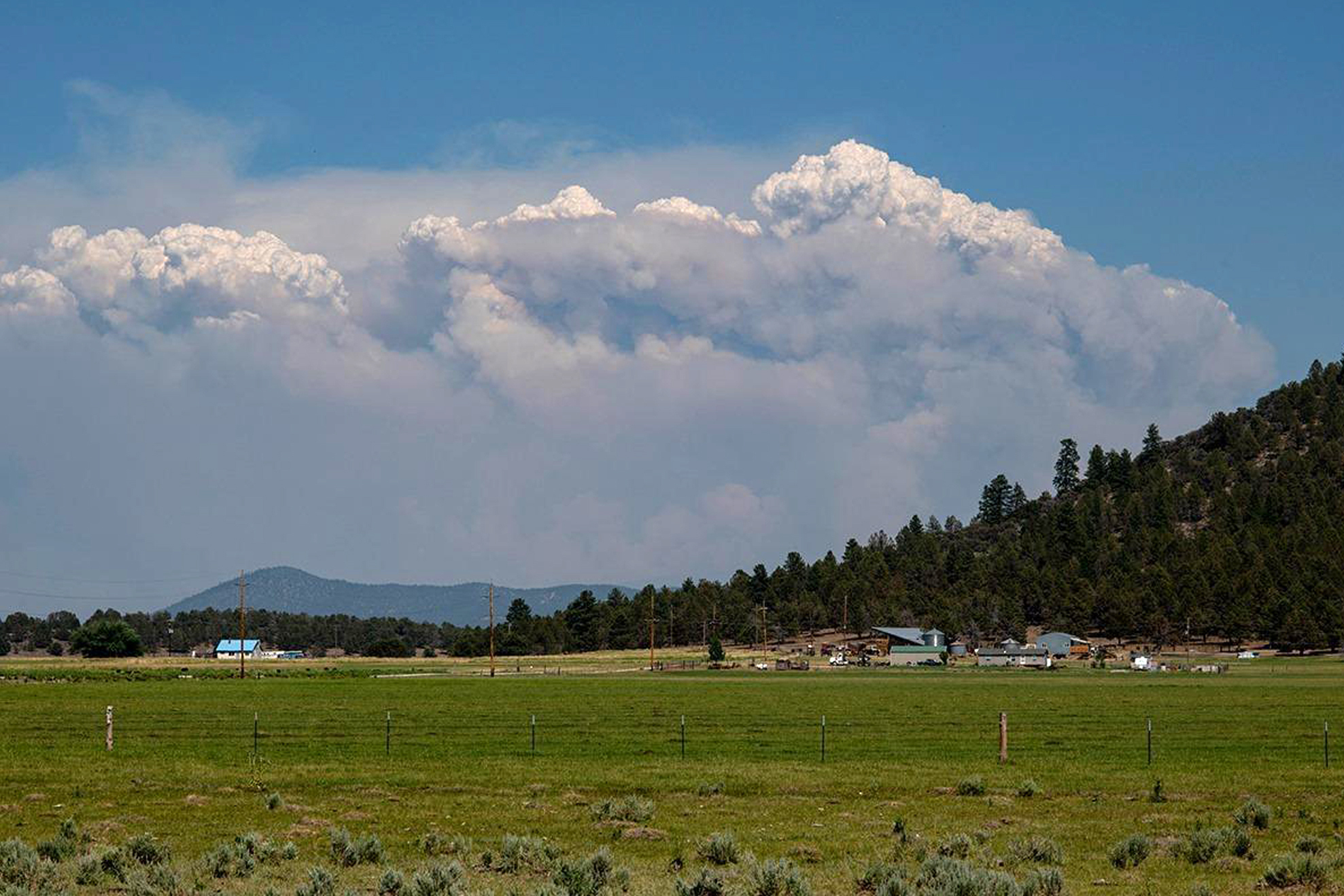 In this photo provided by the Bootleg Fire Incident Command, columns of smoke rise from the Bootleg Fire in southern Oregon on Sunday, July 18, 2021. The threat of thunderstorms and lightning has prompted officials in fire-ravaged Oregon to ask for help from outside the Pacific Northwest to prepare for additional blazes as many resources are already devoted to a massive forest fire.