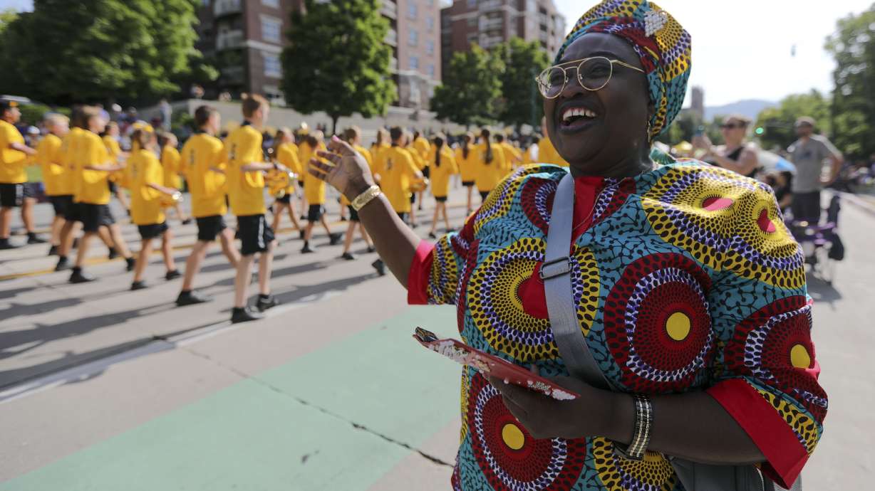 Cariama Kallon-Olayemi dances and sings as a marching band passes by during the Days of ’47 Parade in Salt Lake City on Friday, July 23, 2021.