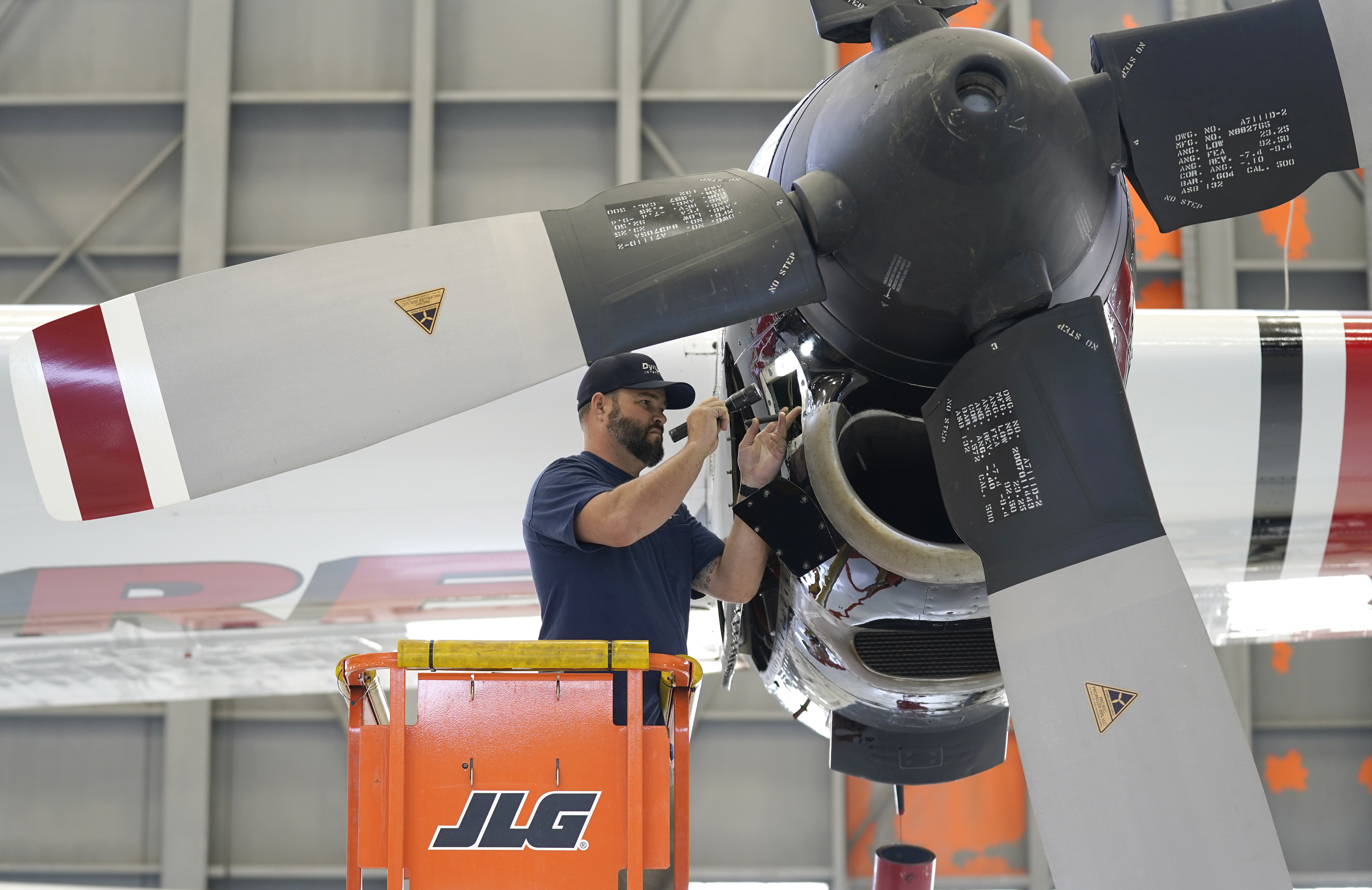 Aircraft Mechanic Cody Poole inspect one of the engines on a recently acquired C-130 aircraft, that will be used for firefighting, hangared at the California Department of Forestry and Fire Protection's Sacramento Aviation Management Unit based at McClellan Airpark in Sacramento, Calif., Friday, July 23, 2021. Firefighters are trying to become smarter in how they prepare for the drought- and wind-driven wildfires that have become more dangerous across the American West in recent years, including by adding aircraft like the Sikorsky Firehawk helicopters or military surplus C-130 transport aircraft retrofitted to drop fire retardant.