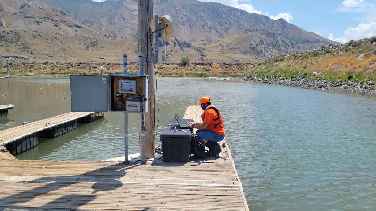 USGS hydrologic technician Travis Gibson confirms Great Salt Lake water levels at the Saltaire gauge. Water levels at the southern portion of the lake have reached a new record low, federal scientists said Saturday.