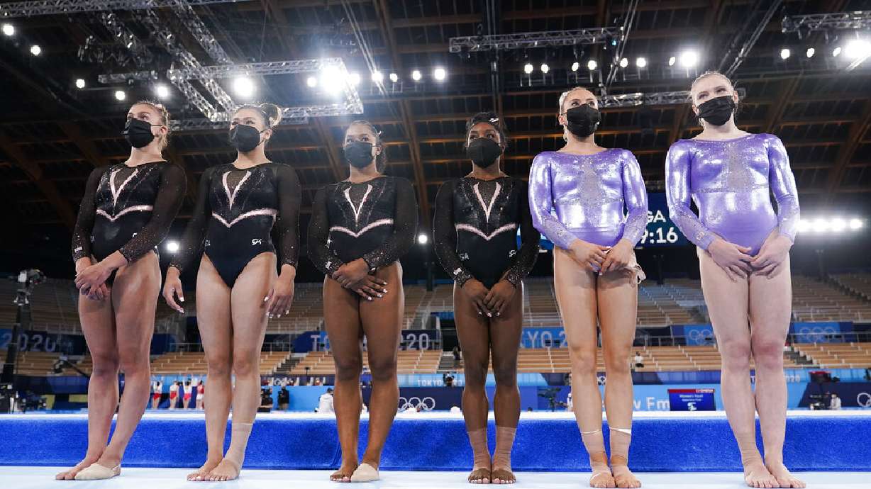 From left, Grace McCallum, Sunisa Lee, Jordan Chiles, Simone Biles, Mykala Skinner, and Jade Carey stand near the floor exercise while training for artistic gymnastics at Ariake Gymnastics Centre venue ahead of the 2020 Summer Olympics, Thursday, July 22, 2021, in Tokyo, Japan.