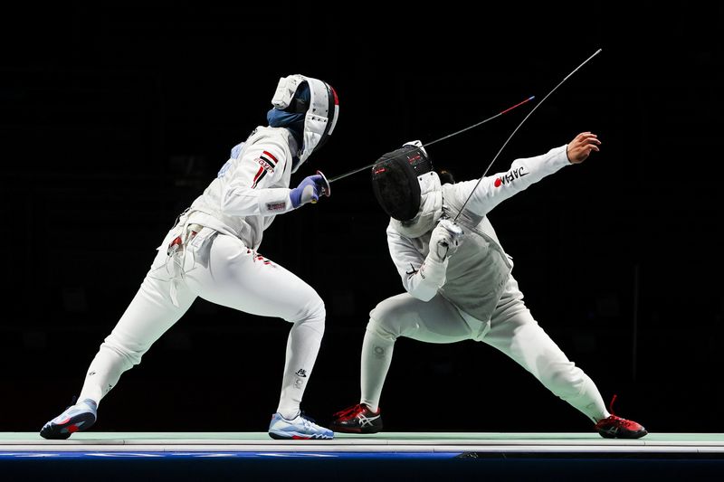 Tokyo 2020 Olympics - Fencing - Women's Individual Foil - Last 32 - Makuhari Messe Hall B - Chiba, Japan - July 25, 2021. Nora Mohamed of Egypt in action against Yuka Ueno of Japan
