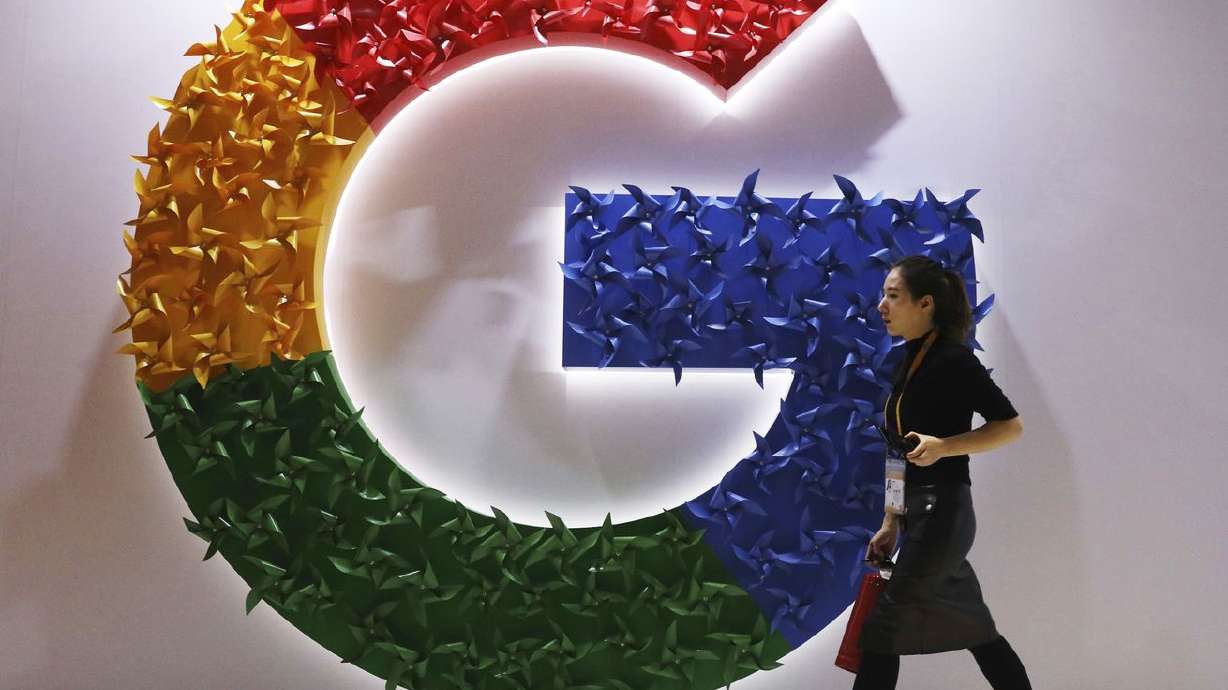 A woman walks past the logo for Google at the China
International Import Expo in Shanghai on Monday, Nov. 5, 2018.
