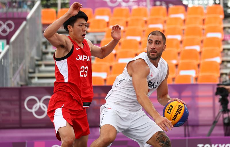 Tokyo 2020 Olympics - Basketball 3x3 - Men - Pool A - Serbia v Japan - Aomi Urban Sports Park, Tokyo, Japan - July 26, 2021.   Mihailo Vasic of Serbia in action with  Ryuto Yasuoka of Japan during the match.