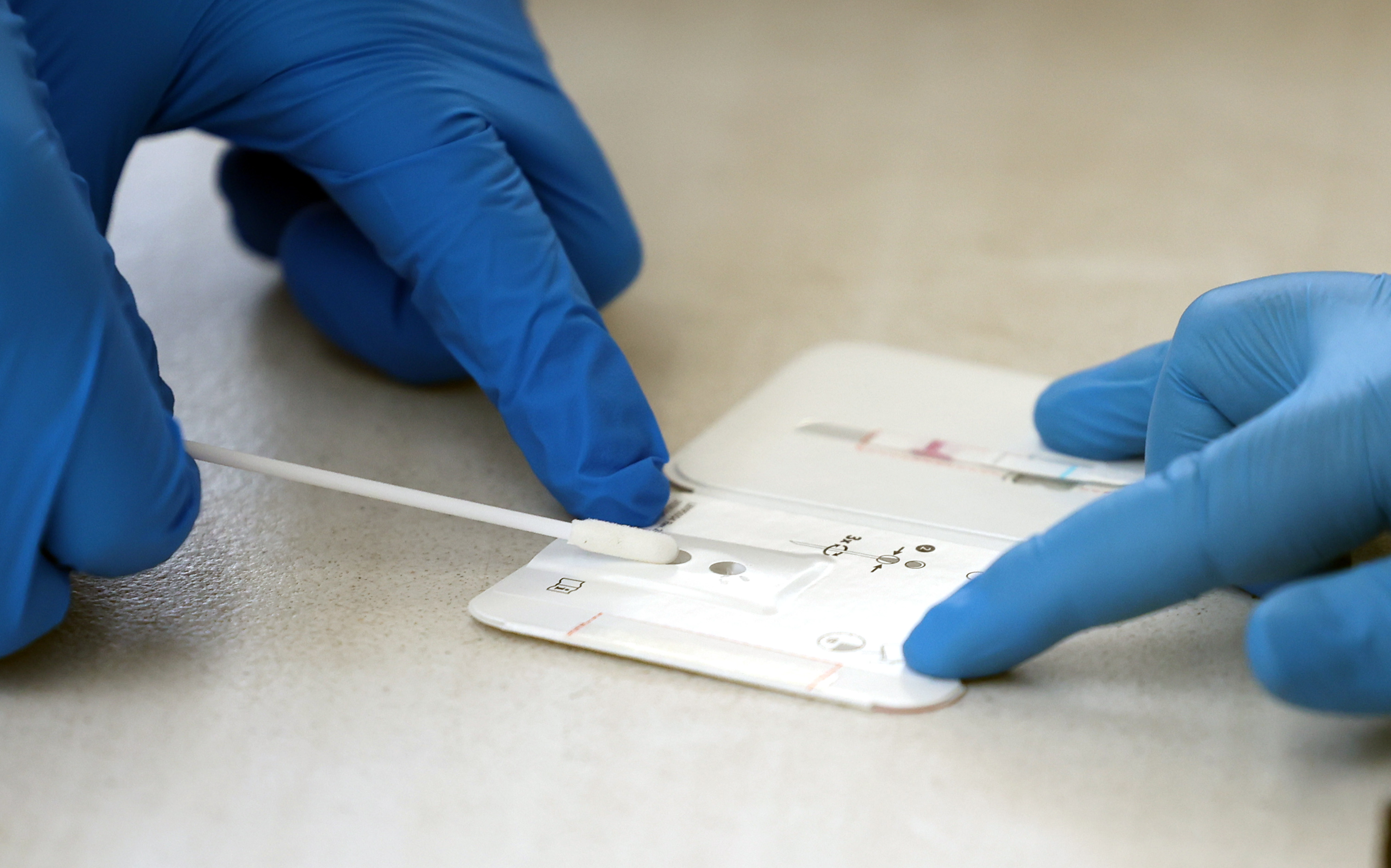 Eric Kwiatkowski, with the Utah National Guard's Forward Support Company in St. George, and Private 1st Class Jacob Osborne, with the guard's 19th Special Forces at Camp Williams in Bluffdale, process COVID-19 tests at the Utah State Fairpark in Salt Lake City on July 6.
