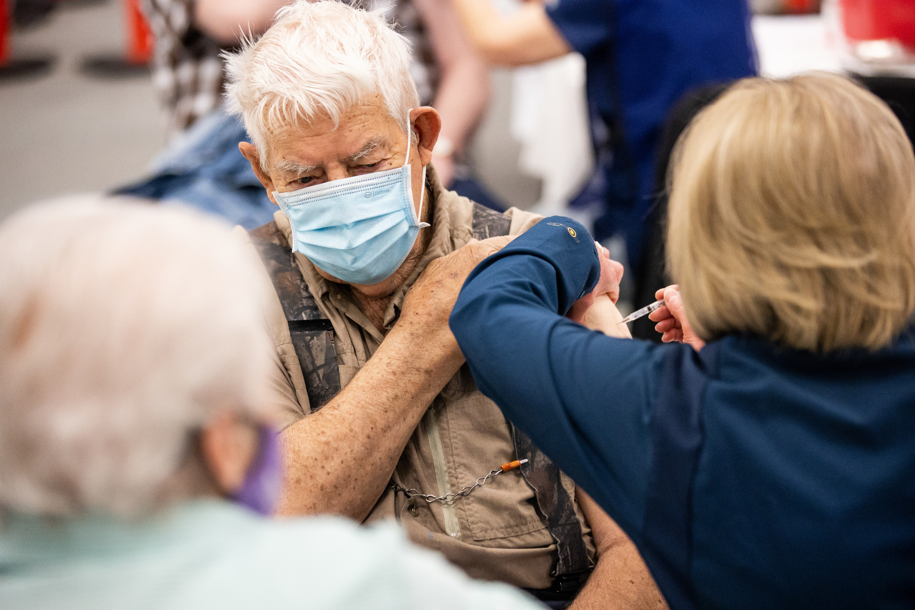 Aaron Dickey, 91, receives a COVID-19 vaccine while his wife, Marion, 83, left, looks on in Spanish Fork on March 25. Marion Dickey said she looked to President Russell M. Nelson of The Church of Jesus Christ of Latter-day Saints when deciding whether to get the vaccination. 