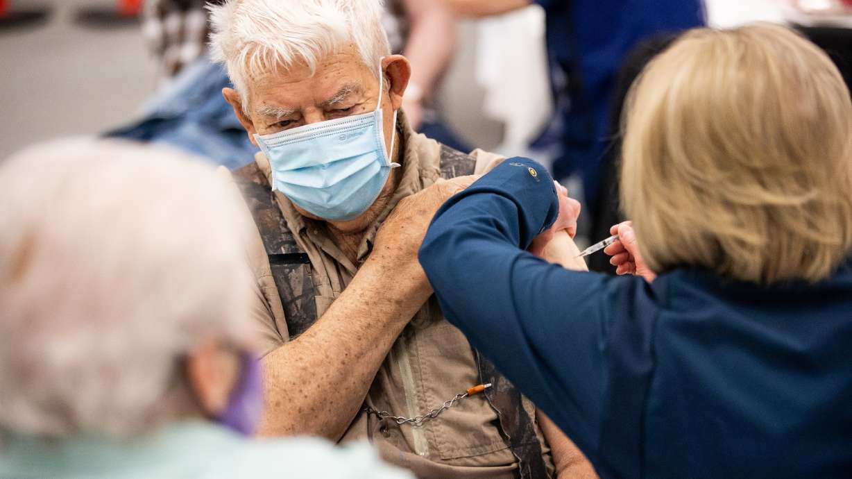 Aaron Dickey, 91, receives a COVID-19 vaccine while his wife, Marion, 83, left, looks on in Spanish Fork on March 25. Marion Dickey said she looked to President Russell M. Nelson of The Church of Jesus Christ of Latter-day Saints when deciding whether to get the vaccination.