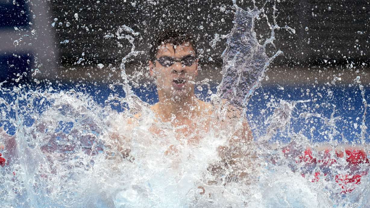 Evgeny Rylov of the Russian Olympic Committee celebrates after winning the final of the men's 100-meter backstroke final at the 2020 Summer Olympics, Tuesday, July 27, 2021, in Tokyo, Japan.