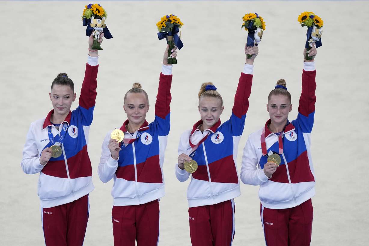 Russian Olympic Committee's artistic gymnastics women's team, from right, Liliia Akhaimova, Viktoriia Listunova, Angelina Melnikova and Vladislava Urazova celebrate after winning the gold medal at the 2020 Summer Olympics, Tuesday, July 27, 2021, in Tokyo.