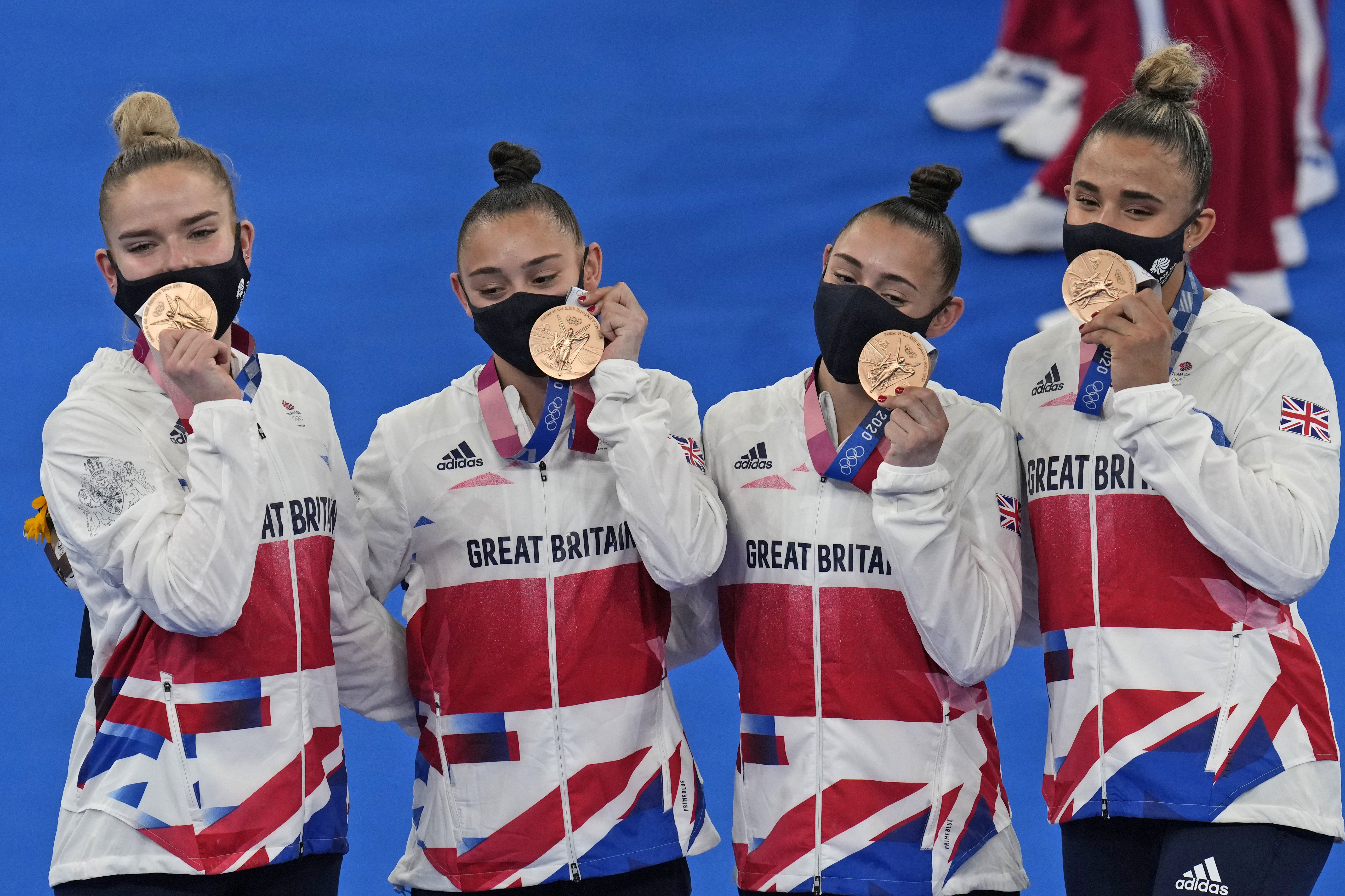 Team Britain, comprising of Jennifer Gadirova, Jessica Gadirova, Alice Kinsella and Amelie Morgan, celebrate after winning bronze in the artistic women's team pose after winning the bronze medal at the 2020 Summer Olympics, Tuesday, July 27, 2021, in Tokyo.