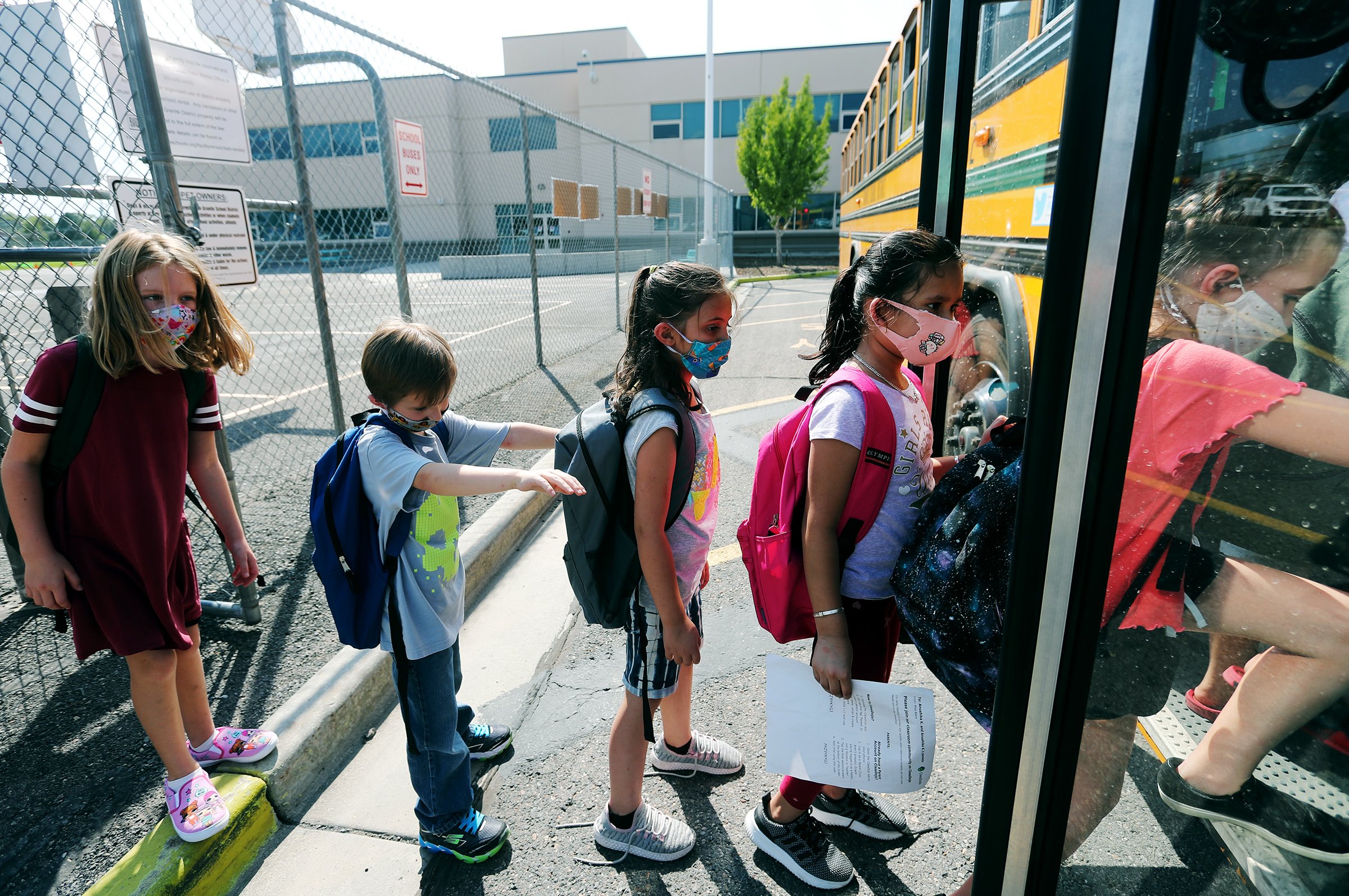 Students at Woodrow Wilson Elementary School in South Salt Lake wear masks as the get on a bus to go home after their first day of school on Monday, Aug. 24, 2020.