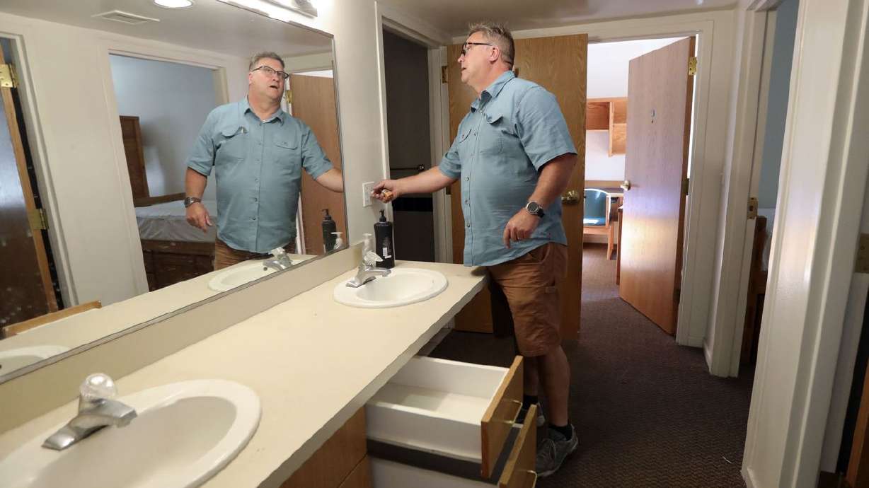 Mark Vittum, Westminster College maintenance
technician, checks lightbulbs and power outlets in an Olwell Hall
dorm at Westminster College in Salt Lake City on Tuesday, June 22,
2021.
