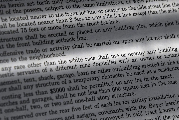 In this Saturday, July 17, 2021, photo, a copy of a covenant for property now owned by Fred Ware is seen in Manchester, Conn. Fred and Dave Ware recently found a whites-only covenant on his property dating back to 1942 when researching the title chain. The covenant described as letter "F" states that "No persons of any race other than the white race shall use or occupy any building or any lot, except that this covenant shall not prevent occupancy by domestic servants of a different race domiciled with an owner tenant."