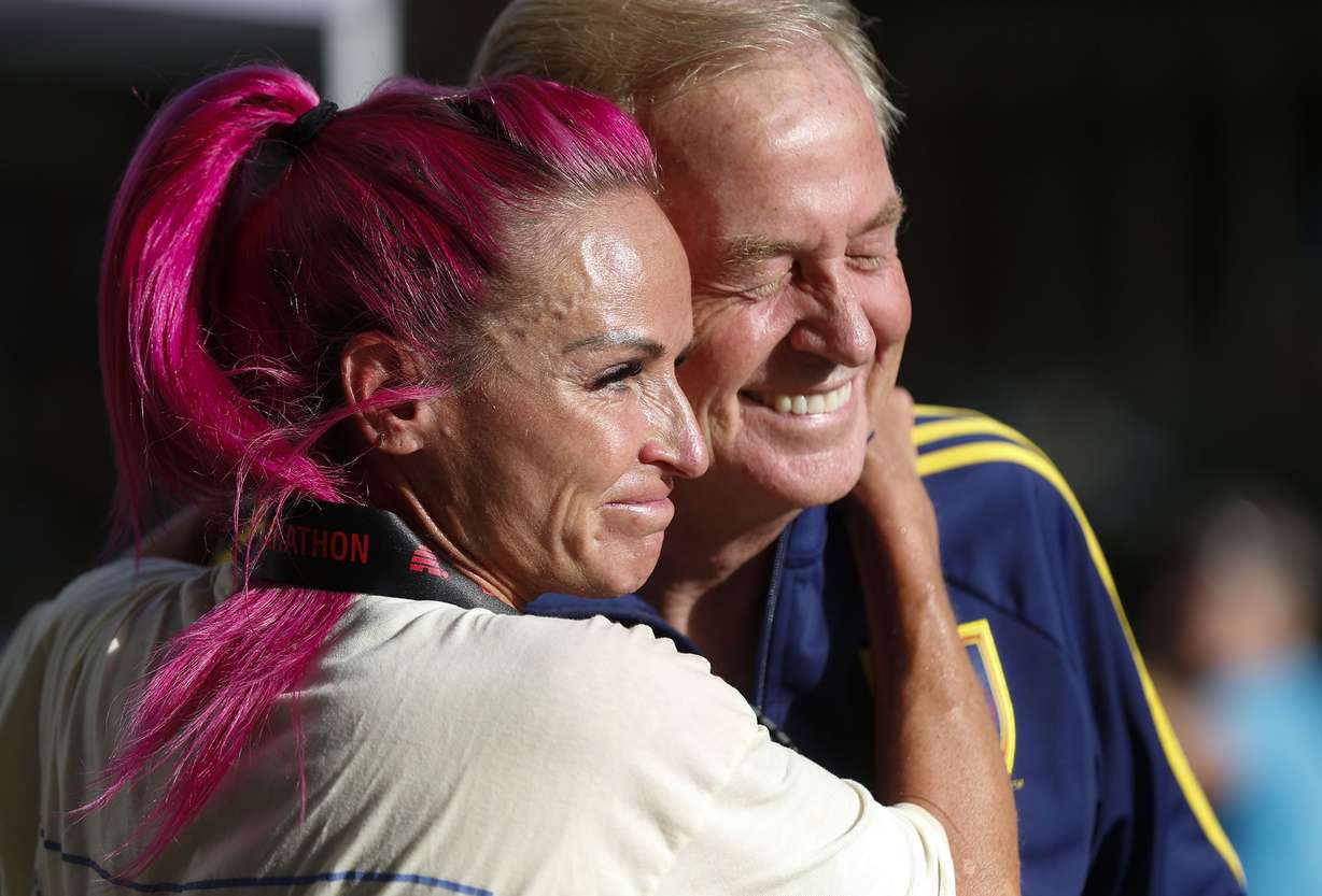 Ashley Paulson celebrates with her father, Brad Jensen, after finishing first in the women's division of the 2021 Deseret News Marathon in Salt Lake City on Friday, July 23.