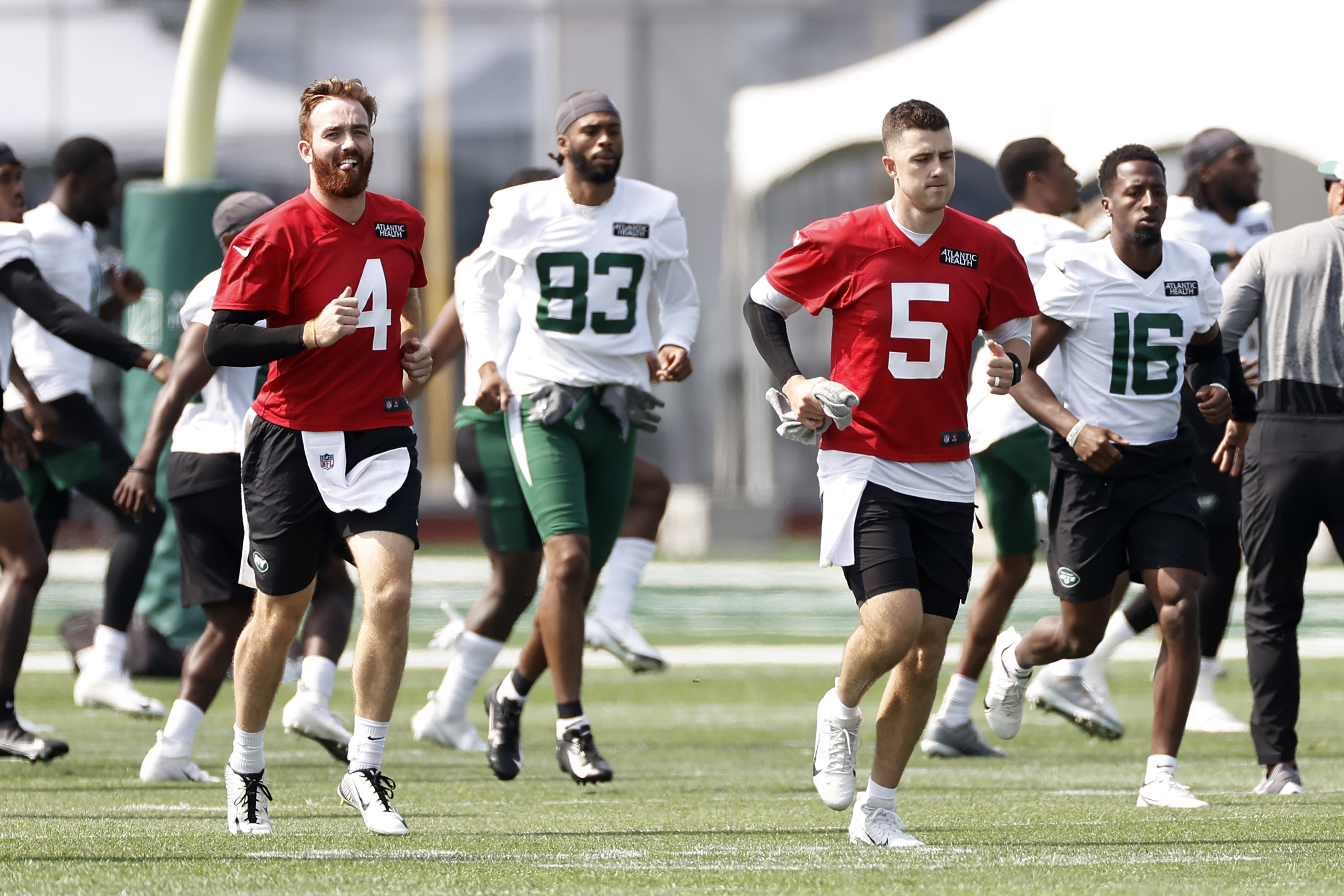 New York Jets quarterbacks James Morgan (4) and Mike White (5) warm up during NFL football practice Wednesday, July 28, 2021, in Florham Park, N.J.