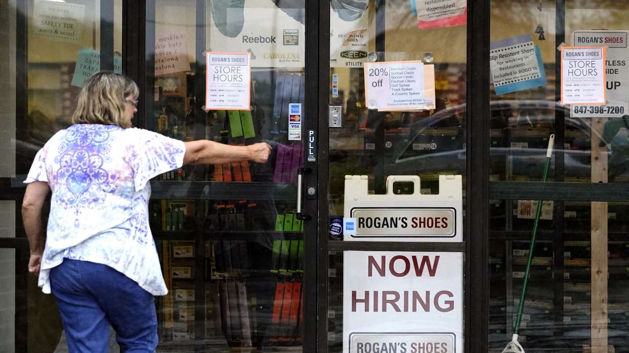 A hiring sign is outside a store in Buffalo Grove, Ill., Thursday, June 24. The number of Americans collecting unemployment benefits slid last week.