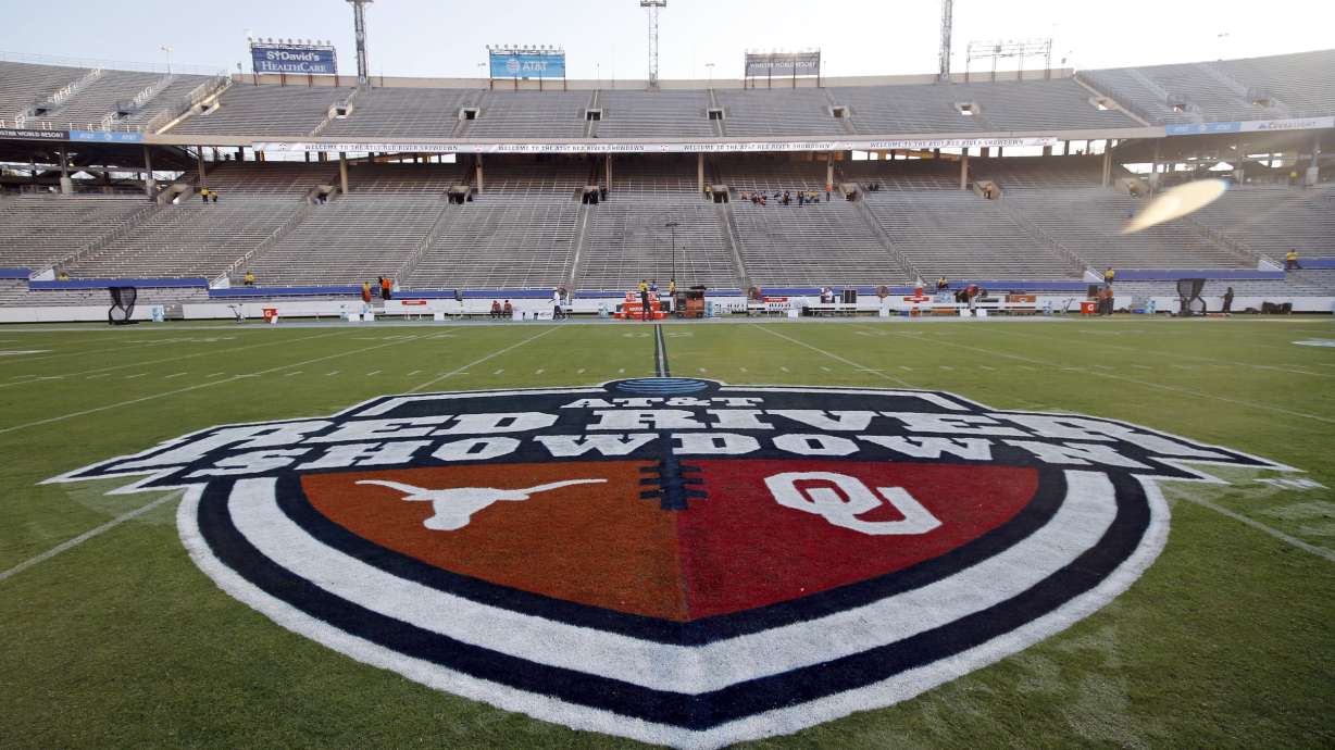 The Red River Showdown logo is displayed on the field of the Cotton Bowl, prior to an NCAA college football game between the University of Texas and Oklahoma, in Dallas.