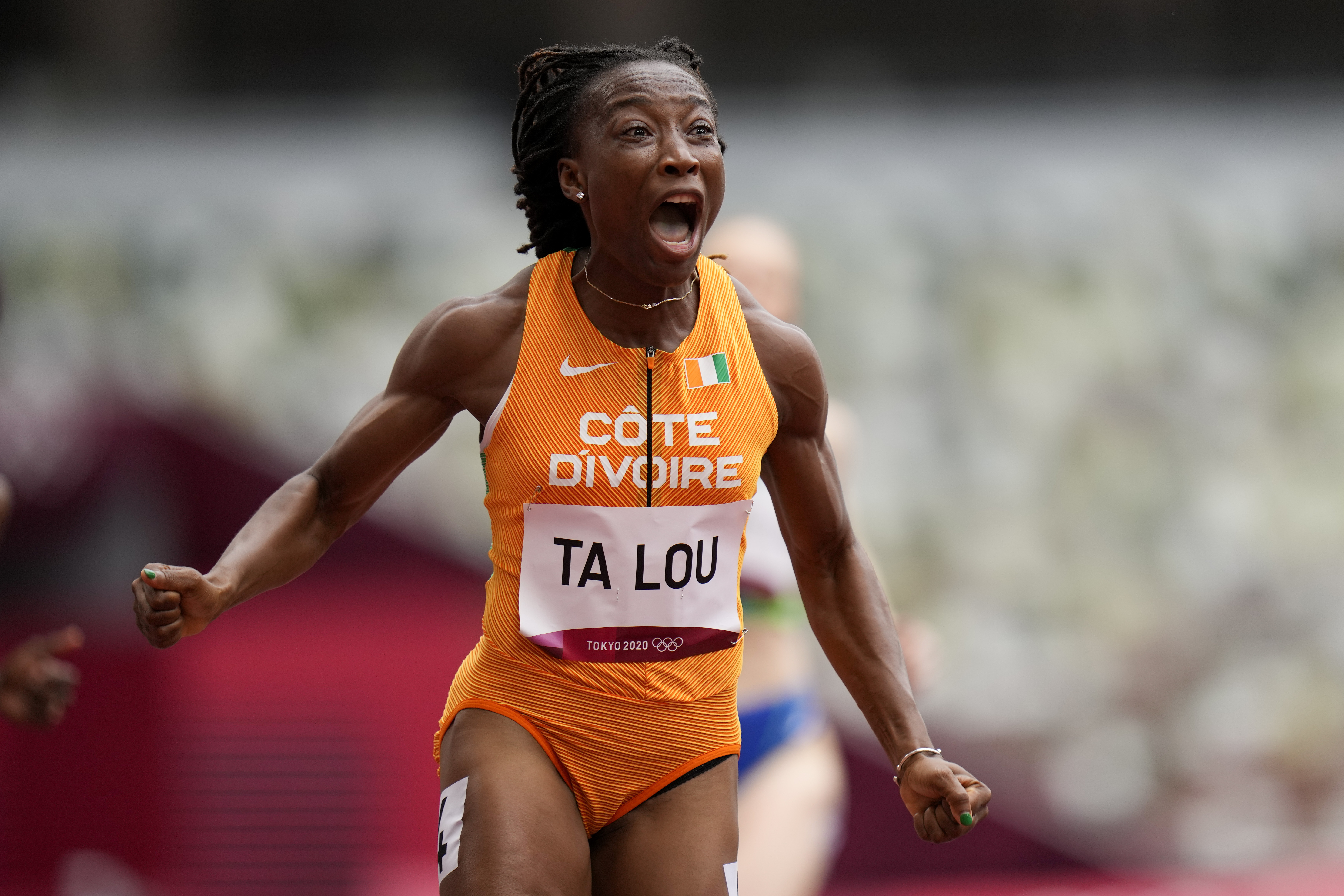 Marie-Josee Ta Lou, of the Ivory Coast, wins a heat in the women's 100-meter run at the 2020 Summer Olympics, Friday, July 30, 2021, in Tokyo. 