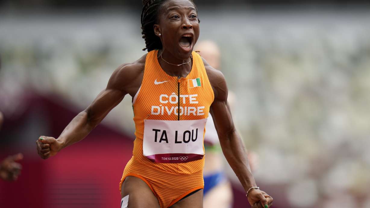 Marie-Josee Ta Lou, of the Ivory Coast, wins a heat in the women's 100-meter run at the 2020 Summer Olympics, Friday, July 30, 2021, in Tokyo.