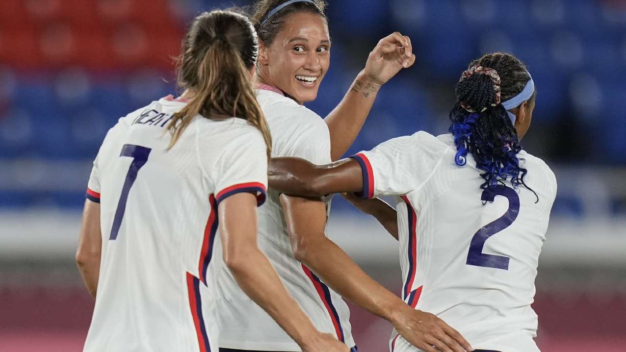 United States' Lynn Williams, center, celebrates with teammates after scoring a goal against Netherlands during a women's quarterfinal soccer match at the 2020 Summer Olympics, Friday, July 30, 2021, in Yokohama, Japan.