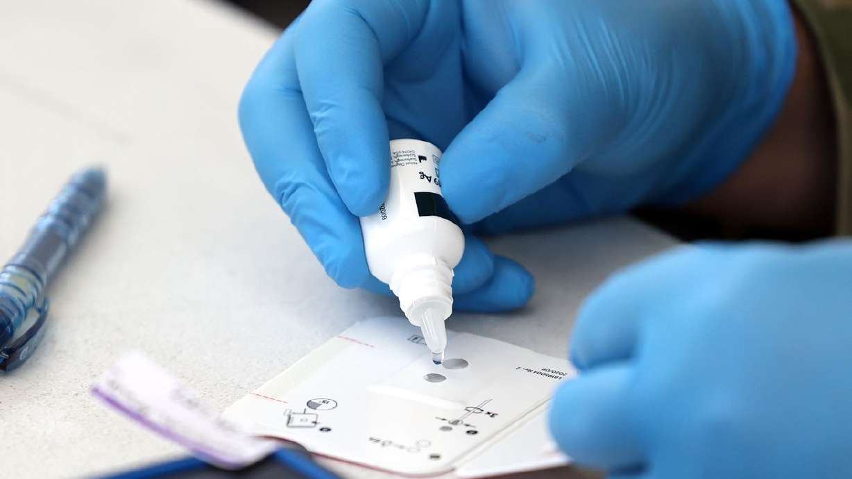 Utah National Guard Pfc. Jacob Osborne, with 19th Special Forces at Camp Williams in Bluffdale, applies a reagent to
a BinaxNOW COVID-19 Ag Card at a COVID-19 testing site at the Utah State Fairpark in Salt Lake City on July 6. Utah health officials reported 4,657 new COVID-19 cases since Friday, as well as additional 27 deaths.