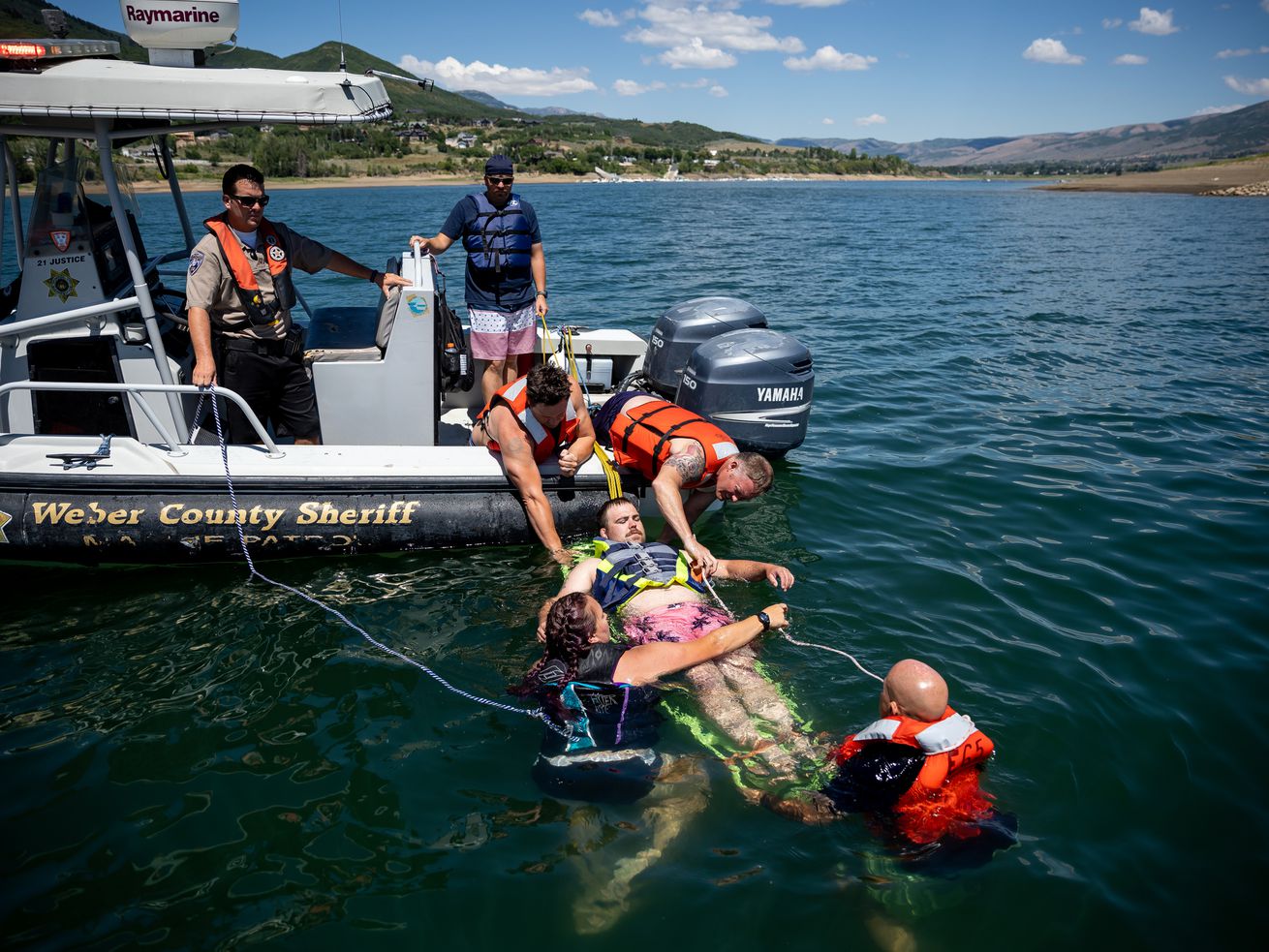 Zane Rich, a Weber Fire District wildland firefighter, is pulled from the water as a mock victim of a boating accident
while Weber Fire District and Weber County Sheriff’s Office personnel practice water rescue training at Pineview Reservoir near Huntsville, Weber County, on Monday.