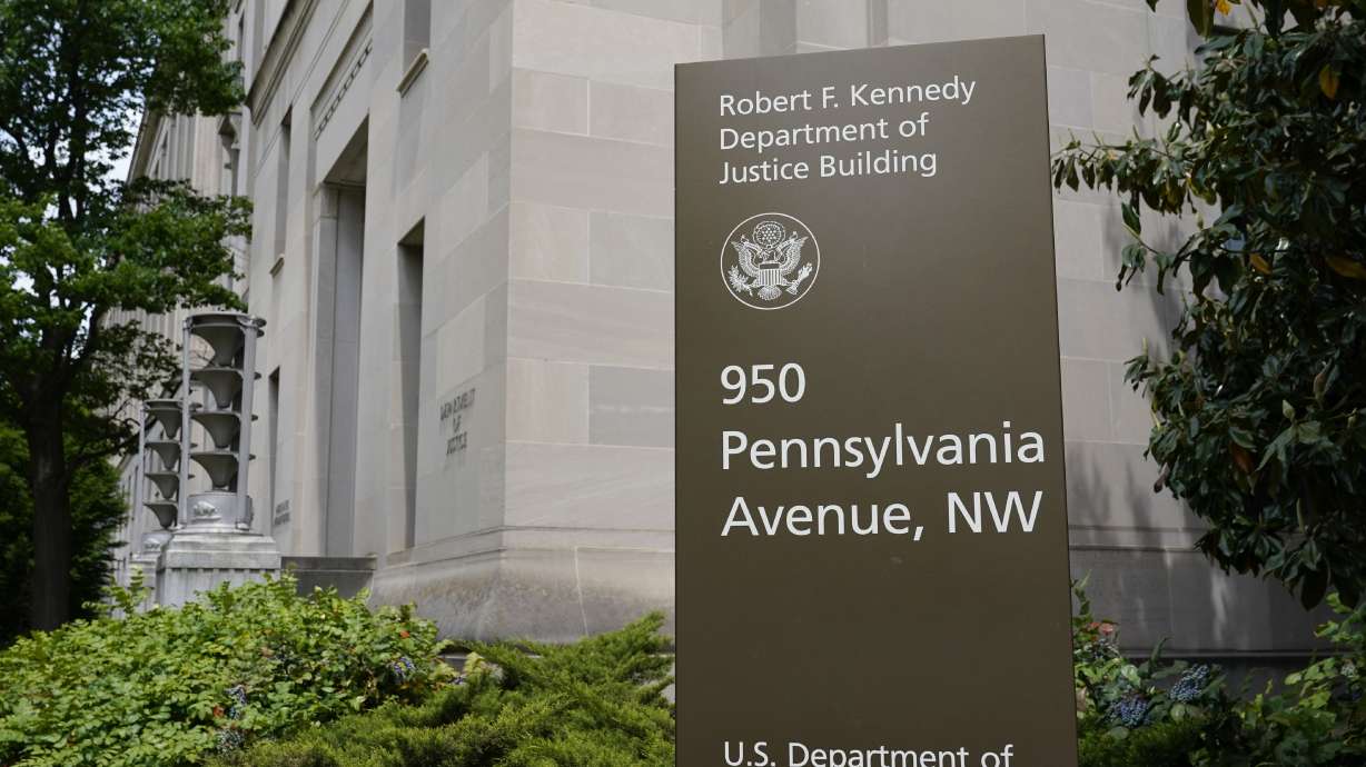 This May 4 photo shows a sign outside the Robert F. Kennedy Department of Justice building in Washington. The Russian hackers behind the massive SolarWinds cyberespionage campaign broke into the email accounts of some of the most prominent federal prosecutors’ offices around the country last year, the Department of Justice said Friday.