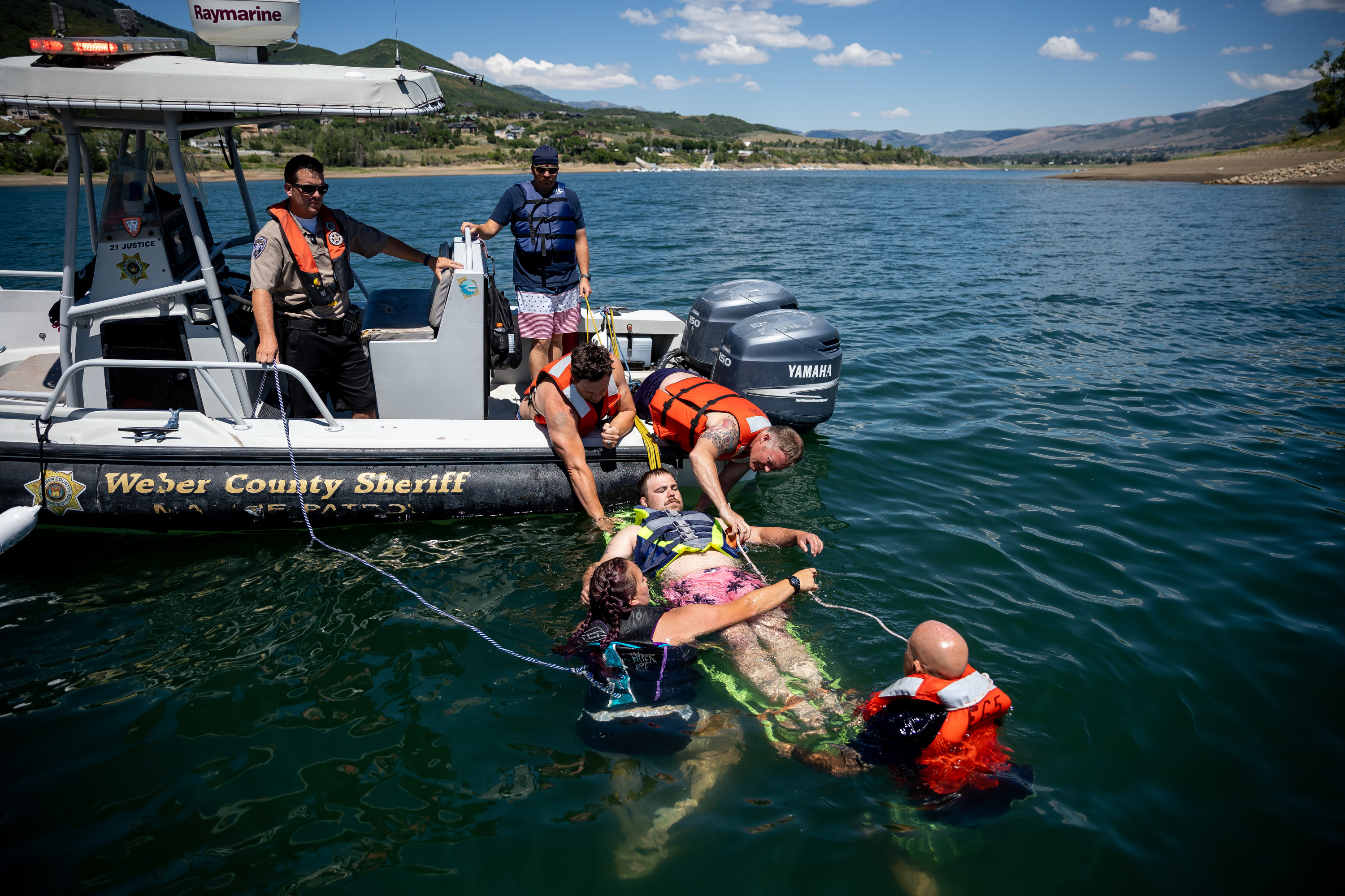 Zane Rich, a Weber Fire District wildland firefighter, is pulled from the water as a mock victim of a boating accident while Weber Fire District and Weber County Sheriffâ??s Office personnel practice water rescue training at Pineview Reservoir near Huntsville, Weber County, on Monday. Rich's would-be rescuers are, clockwise from bottom right, firefighter and advanced emergency medical technician Mike McKinney, firefighter paramedic Rashelle Johnson, Capt. Brian Lutz and engineer Scott Buehler.