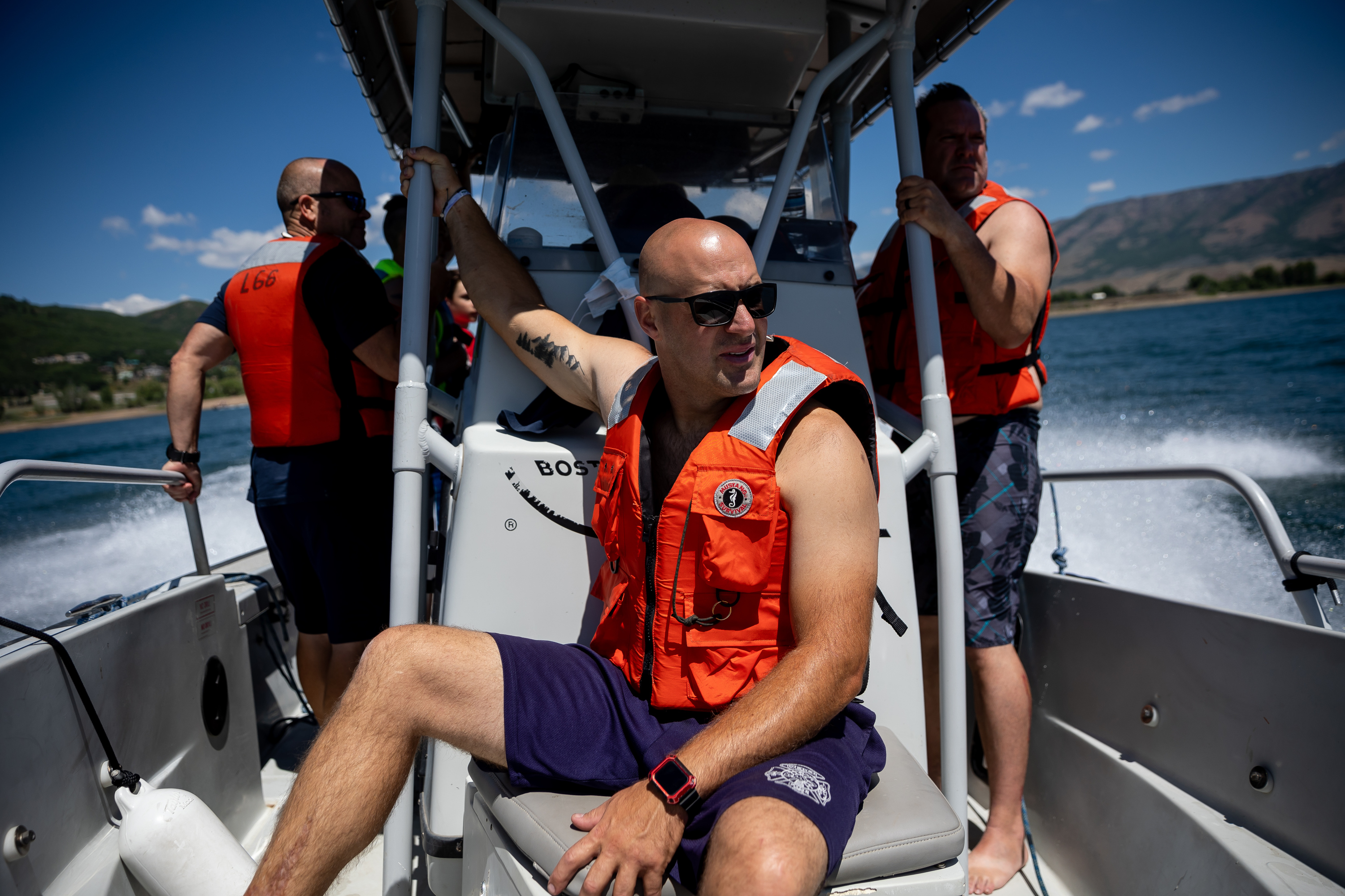Jason Campos, a Weber Fire District firefighter and advanced emergency medical technician, center, rides on a Weber County Sheriff’s Office boat while the two agencies practice water rescue training at Pineview Reservoir near Huntsville, Weber County, on Monday.