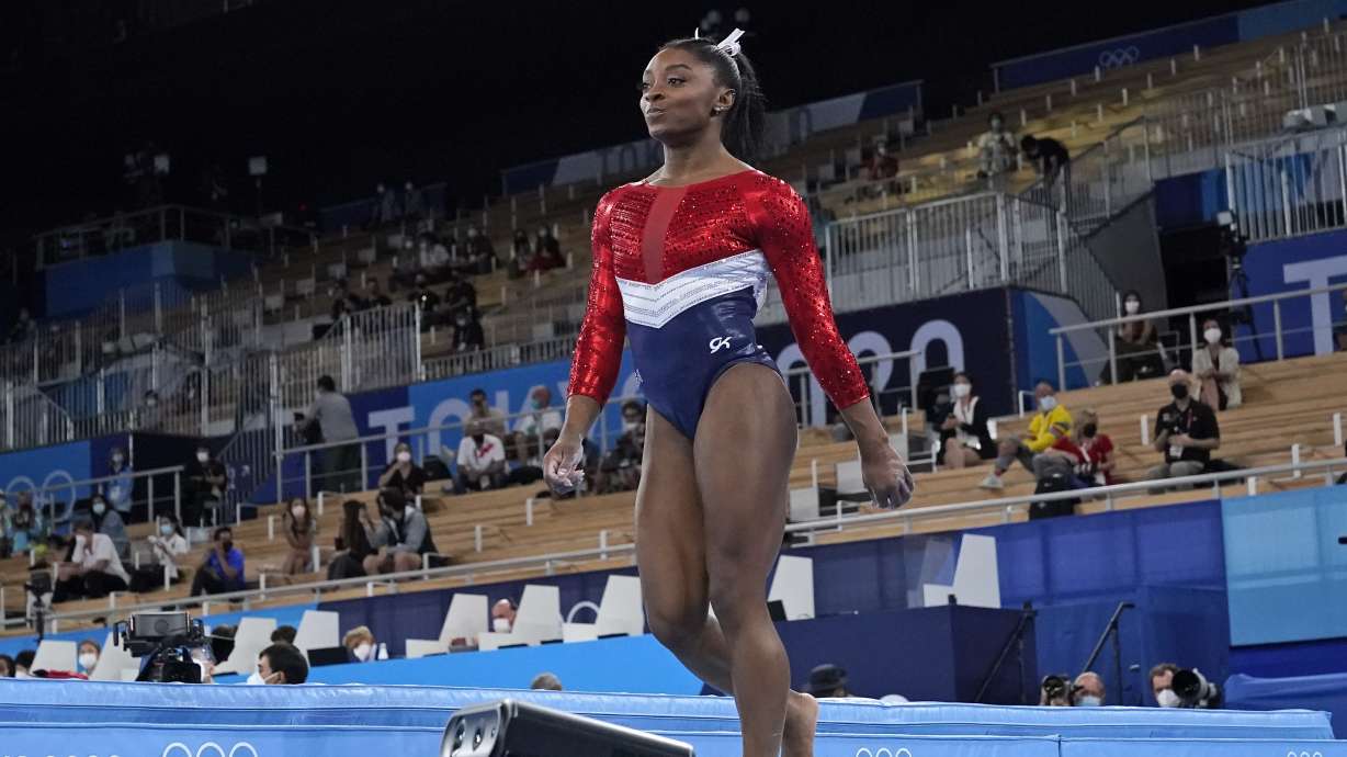 Simone Biles, of the United States, walks after performing on the vault during the artistic gymnastics women's final at the 2020 Summer Olympics, Tuesday, July 27, 2021, in Tokyo.